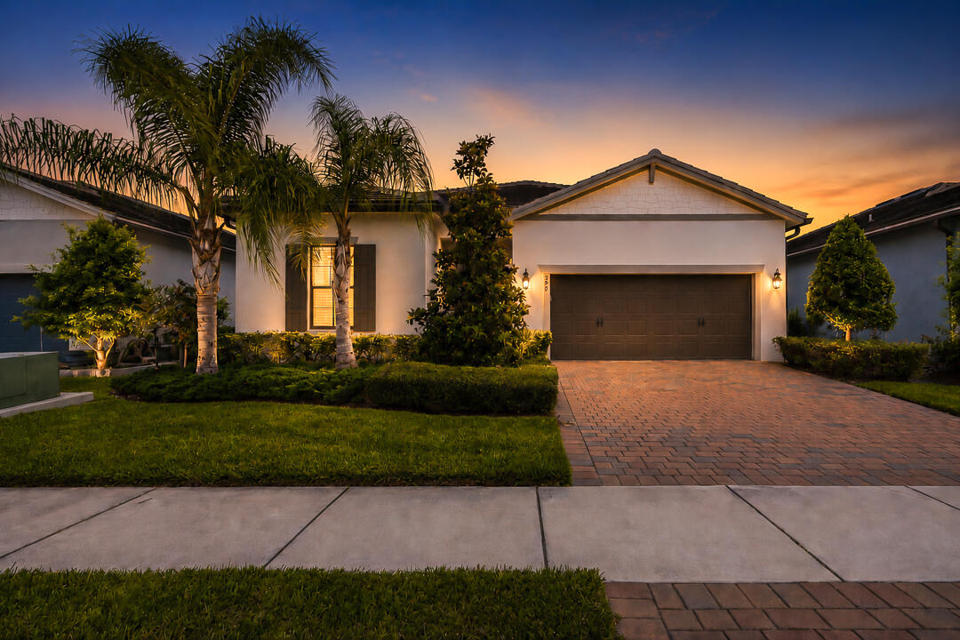 WOW! Move-in ready - loaded with upgrades, this exceptional 3-bedroom, 2.5-bath lakefront home in Veranda Gardens offers luxury and value. The designer kitchen features quartz countertops, stunning backsplash, oversized island with added storage, large walk-in pantry, soft-close cabinetry, glide-out drawers, wall oven, gas cooktop, vent hood, and stainless-steel appliances. The open-concept layout flows to the spacious living area and extended covered paver patio overlooking the lake. The premium primary suite offers tray ceiling, two walk-in closets, and a spa-like bathroom with dual sinks, quartz countertops, and an extended walk-in shower. Impact windows and doors, smart home technology, soaring ceilings, elegant 8' wood doors, wood-look tile flooring throughout. Plus room for a pool! Located in the sought-after gated community of Veranda Gardens renowned for its warmth, hospitality and pet friendliness. Living in Veranda Gardens means access to fantastic amenities including a Clubhouse, resort-like heated pool, spa, lap pool, cabanas, tennis, pickleball, basketball, bocce ball, fitness center, community room, catering kitchen, barefoot bar, BBQ grills, fire pit, grills, playground, dog park, sidewalks, street lights, lawn maintenance and all with a LOW HOA fee. Conveniently located with easy access to the FL Turnpike, I-95, shopping, dining, golf, baseball, the beach, and a new hospital - this home offers the complete package.