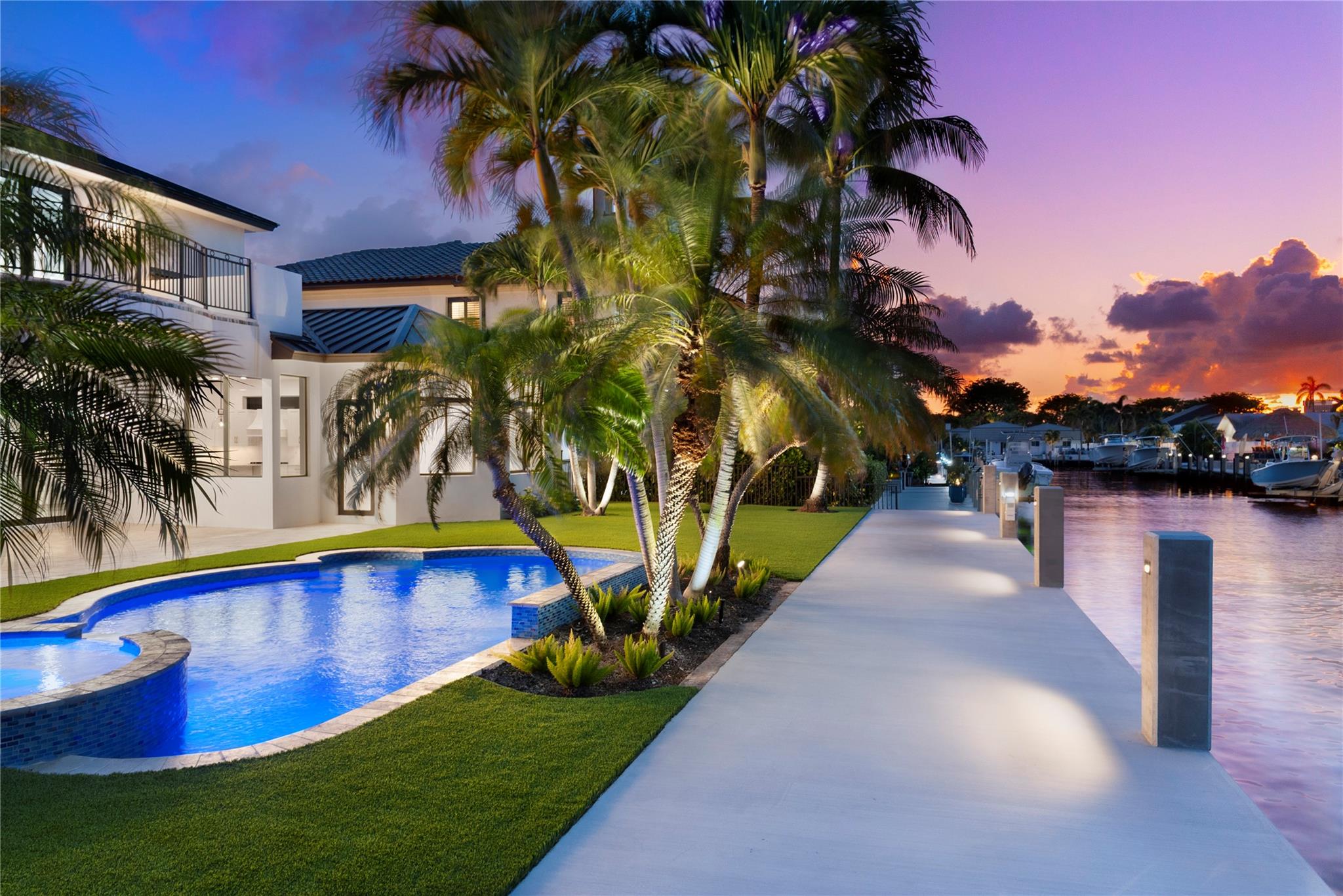 Luxury living in Coral Ridge Country Club. Modern sophistication and timeless elegance.  Great open floorplan for entertaining & raising a family. Enjoy South Florida living with the most amazing backyard with new Concrete dock, pool, spa, summer kitchen, covered patio, & lush landscaping. First floor large master suite with voluminous ceilings.  New metal roof, Epoxy flooring in garage, Laundry room upstairs and down. Private dock just off Intracoastal. Minutes to beach, shops, dining, tennis, golf and park. Won't last long.