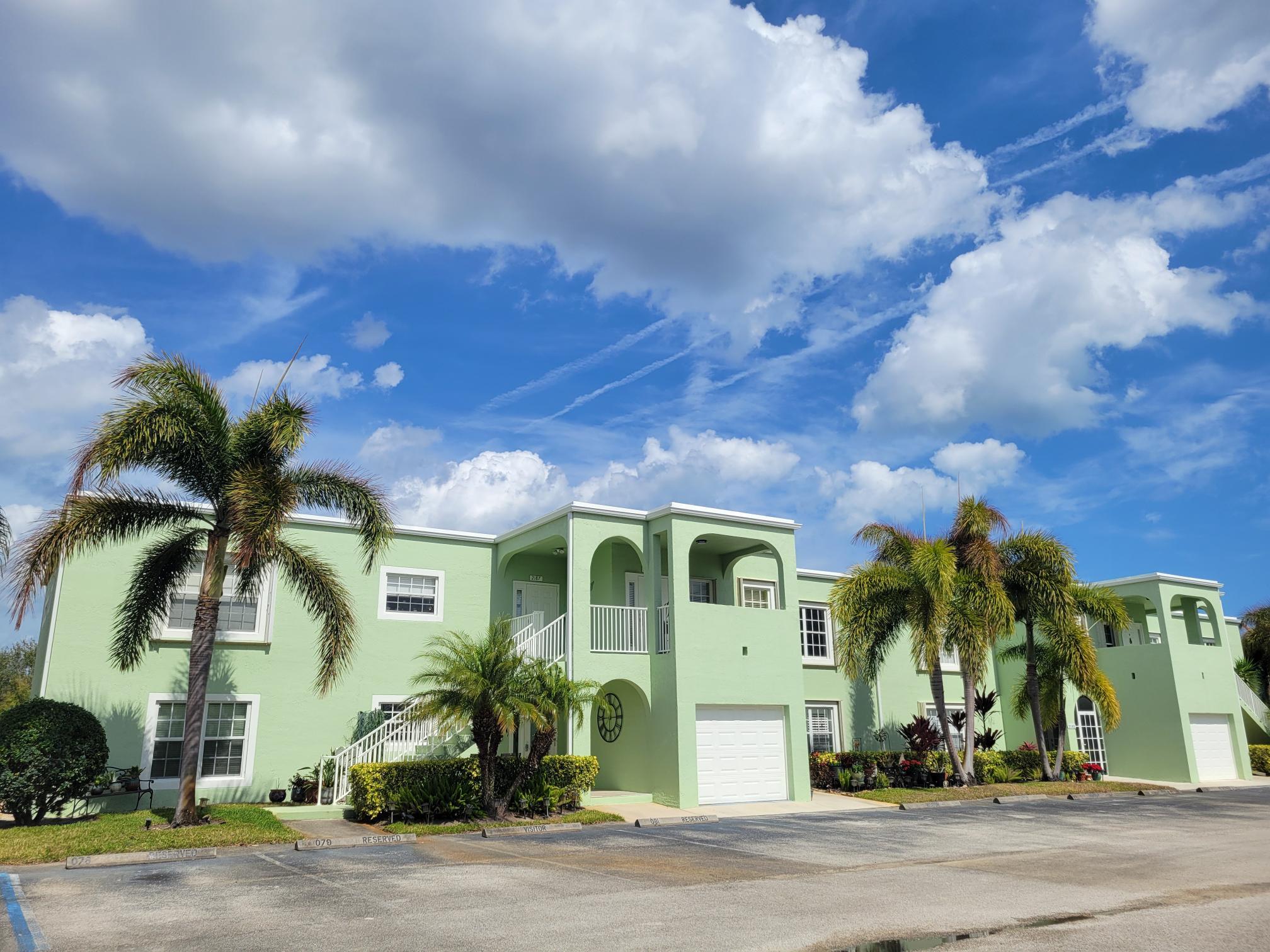 ASSUMABLE MORTGAGE 5.875%, Can also Lease Option 1 Year. CALL FOR DETAILS.  Rare opportunity now available with accordion shutters and a new roof WINTER of 2024 with just over 1,550 sf under AC and just under 2,000 total sf.  2 bedrooms, 2 baths split open plan, no carpet, covered patio and ALL-season porch 21 x10 with central air conditioning.  AC bills in Summer never go over $100.00 dollars.  Very energy efficient unit. Wide water views from the rear porch.  Near to the beaches as well!   From the moment you open the front door every room is bathed in energizing natural light.  Small Foyer landing entrance opens to breakfast bar on Left and breakfast nook on right.  The kitchen is the heart of this spacious home, (see supplemental info) true cook's kitchen with a glass backsplash that adds visual interest and accents the thick granite countertop.  The counter space goes on and on with so many cabinets and drawers, a place for everything and everything in its' place.  Crown moldings grace the top cabinetry and is repeated at the ceiling as well as throughout the entire home. An elegant but refined touch.  All kitchen appliances stay as seen, including the osmosis with filter at sink.  Large porcelain floor tiles cut on a diagonal visually magnify the gathering areas throughout the home.  ***For anyone who works from home or telecommutes it can be difficult to carve out a home office.  But not here, much thought and preparation has been made for that beautiful matching granite for this built in office opposite the kitchen will put all home offices to shame.  Room for two computer screens, two printers, a writing area, as well as drawers for files and cabinets for supplies.  You can seamlessly power down and lock up in minutes when the children come home or guests stop in. This home has nonstop storage next to the home office as well as the spacious laundry room where you can have even more storage with some extra cabinets that you add. The sleeping areas are just off the gathering room and kitchen, down a short hallway.  Left door is Master, Center is Guest bathroom, Right door is Guest bedroom.  HUGE MASTER is 16.8 x 13.2 of useable floor space (room is larger) Master has slider that opens to HUGE All-Season porch, two flanking closets with mirrors in Master with hidden cabinet storage.  Master bath vanity area has one water basin, but can easily accommodate two.  Large enclosed glass shower rounds out the master bath.  The slider that leads from Master to Huge Porch is 21 x 10, this all-season porch offers windows that reconfigure into 2/2 split, 3/1 split or all 4 up.  Currently air conditioned or heat or use the windows and it becomes a screened in porch.  You decide.  Laundry room is just off Master with 9 x 8.2 size bigger than most bathrooms.  SOOO much storage.  Could be additional pantry, could be sewing room, could be fish tackle room, could be hobby room...could be your special room.  The guest bedroom is generous in size 16.6 x 12.2 and has natural sunlight streaming in all day long.  Mirrored closet doors and closet maid shelving add more useable space.  From the porch you can enter back into the master retreat, or you can walk to the other end and enter the large living room which also has a slider too and overlooks the semi-formal dining room which is adjacent to the kitchen pass thru.  This open floor plan lives large and can be anything you want the rooms to be as you are not limited.  AC bills well under $100.00 even in Summer!  The condo association offers several amenities that come with your monthly/quarterly condo fees for the whole family.  A large pool, a spa, a sauna, tennis courts to name a few, plenty of places to jog or walk within the community as well.  Sometimes a garage comes up for rent so check the bulletin board daily.  The hospital is only 6 minutes away.  The beaches are only 12-15 minutes away.  This area East of U. S. 1 is growing.  You can walk or bike to the Civic center that was built not too long ago, take in one of the venues offered which changes weekly, plays, music, theater, always something happening here, even parades!  Publix grocery store across the street from the Civic center on Walton road with additional shopping, restaurants is just minutes down the street too.  Easy access to U. S. 1 and the beaches.  Take Walton East over the Hill to the "T", make a right. Beaches on Left over bridge.  Want to skip the U. S. 1 traffic? Go to Jensen Beach? Take Walton East make a right onto green river parkway from Walton as it exits at Jensen Beach take a left.  Ocean directly East just over the bridge.  Call your agent now and make an appointment to see this rare opportunity to own big square footage all on one floor. Very Low AC Bills.