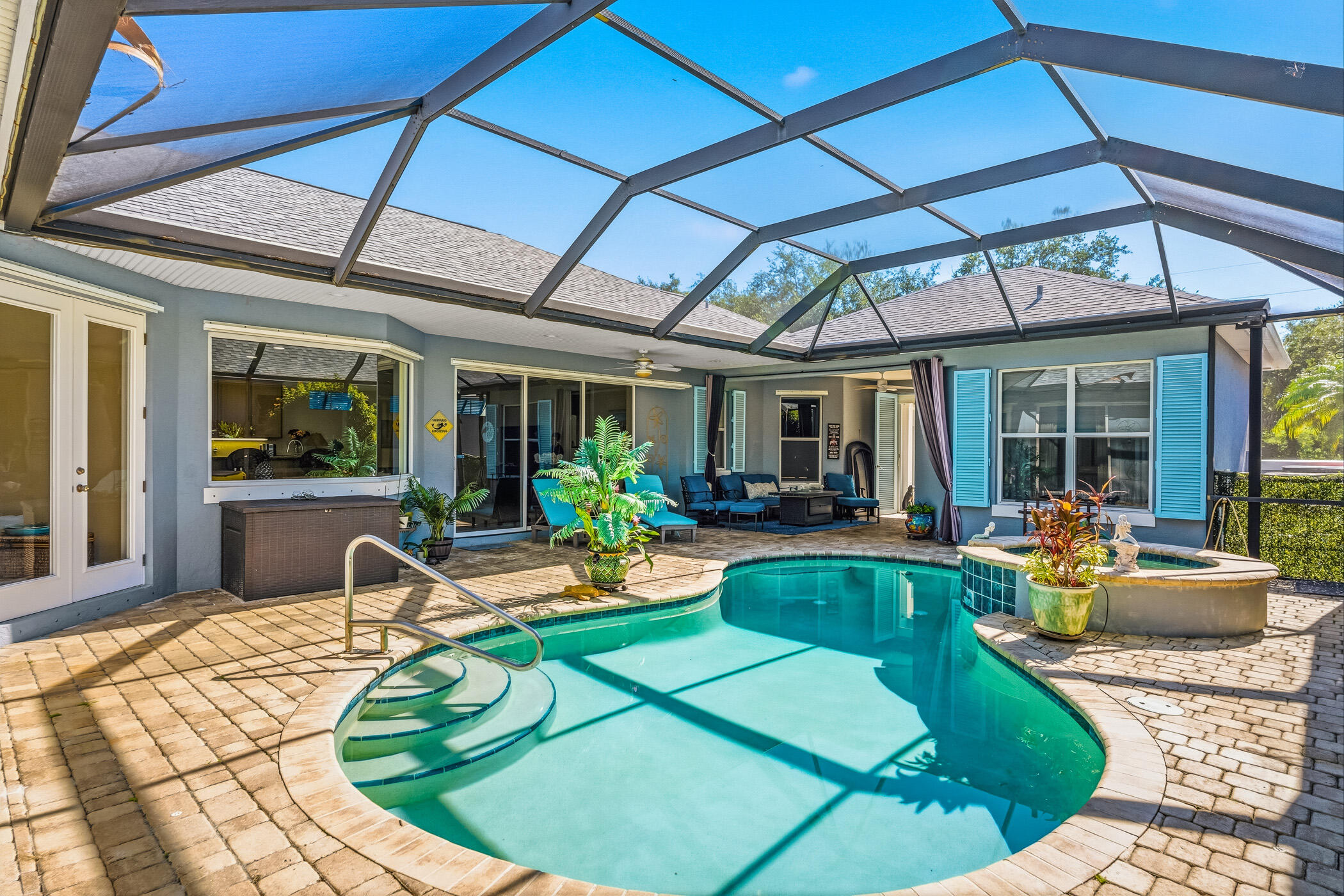 Ready for your quick move in-Freshly painted throughout & newly carpeted bedrooms. Roof '24. Lovely courtyard style home set amongst old oaks & offers an enclosed glass porch overlooking Hammock Lake. Perfect spot for watching TV or Mother Nature! Unique floor plan with 2 BR's in main house & separate cabana BR & BA for guests or office. Great entertaining home w. so much outdoor space!