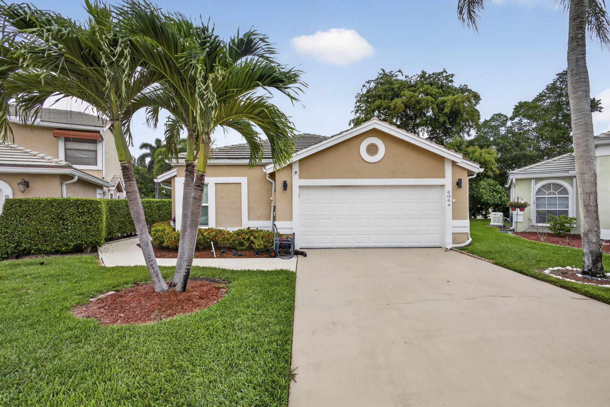 Enjoy sweeping golf course views from this beautifully maintained 2-bedroom plus den home perfectly positioned on the 13th green. Designed for comfortable Florida living, this residence features a spacious open floor plan, an inviting eat-in kitchen, attractive flooring throughout  and a custom built-in bar ideal for entertaining. Expansive windows create the perfect setting to relax and take in the serene fairway views.  Residents enjoy resort-style amenities including a heated pool, clubhouse, fitness center, golf course and pro shop, all within a gated community with 24/7 manned security. A wonderful opportunity to enjoy relaxed, country club living. Atlantic National is a public course with all the class, beauty, and amenities of a private club. Tenant is responsible $89.00 a month for cable payable to the owner with the rent