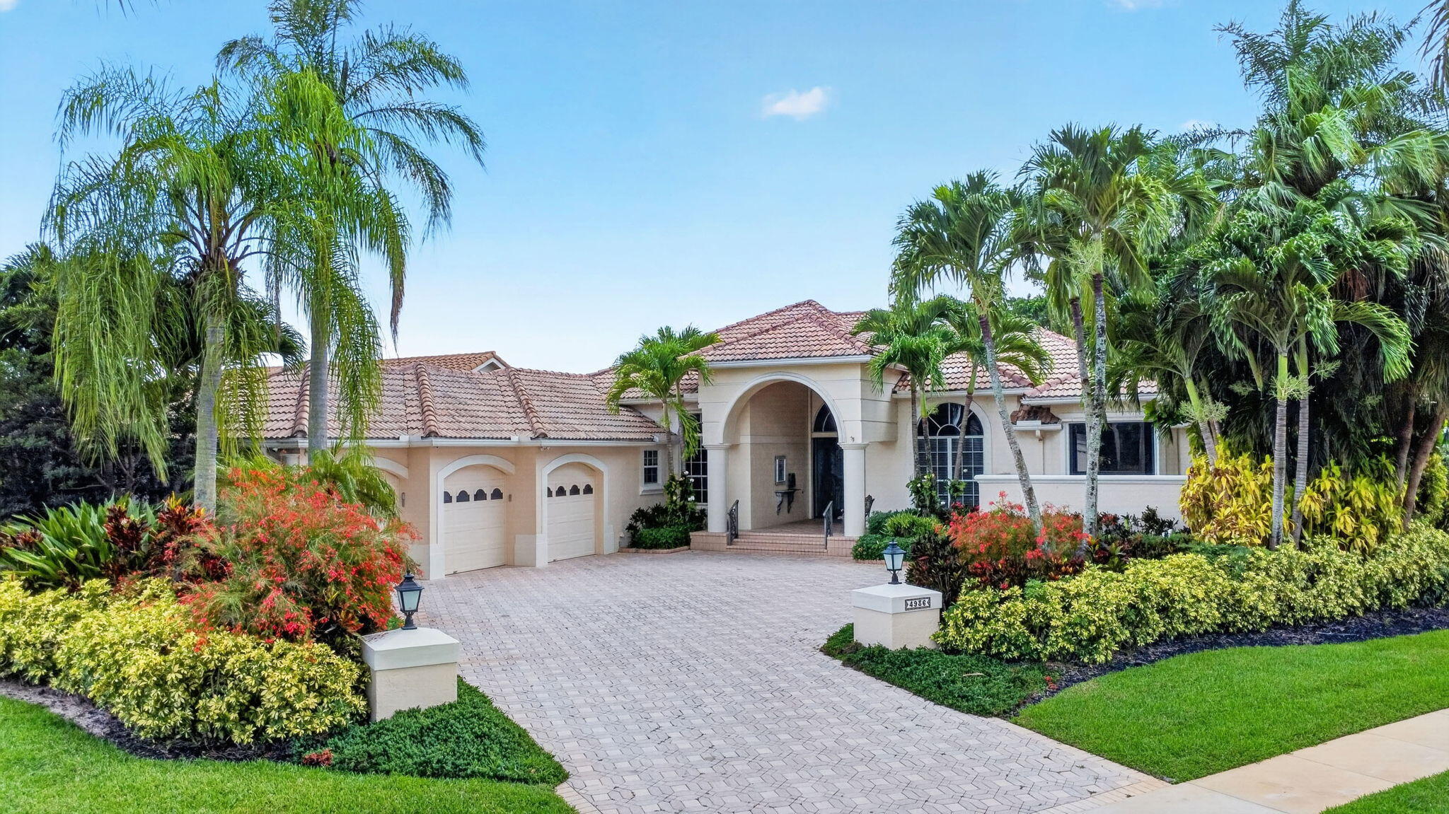 Rare opportunity in the prestigious Exeter Estates at Wycliffe Golf & Country Club! This unique 4BD/4BA home features a private guest wing with two bedrooms, two bathrooms, and its own kitchenette, making it ideal for extended family, guests, or multigenerational living. The open floor plan is enhanced by tile flooring throughout the main living areas and vinyl flooring in the bedrooms. The kitchen offers granite countertops, wood cabinetry, stainless steel appliances, and a step-down bar, perfect for entertaining. Expansive sliding glass doors open to a large screened patio and pool, creating seamless indoor-outdoor living. The backyard is beautifully finished with artificial turf and a private putting green, providing the perfect setting to relax and enjoy the South Florida lifestyle.
