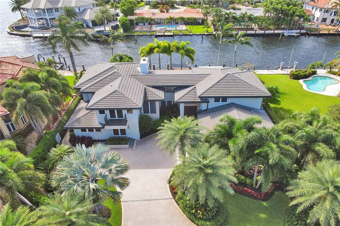 Magnificent completely renovated organic modern home w/ breathtaking Intracoastal views situated one from the point. Enter through the unique rotating front door into a bright volumed ceiling glass walled designer beauty. Custom Eat-in chefs kitchen w/ Subzero & Miele appliances overlooking family room. Lounge w/ full bar & Subzero wine towers, ideal for entertaining. Spacious downstairs office could be second primary bedroom. Upstairs is a custom primary bedroom suite w/ rotating television wall & sitting area. Spa style master bath w/programmable steam shower, jets & rain bath. 2nd oversized office w/lots of light & unique cork flooring. 2 additional guest suites. Southern exposure overlooking the deep water canal. Great outdoor entertaining w/heated saltwater pool, boatlift & bbq area