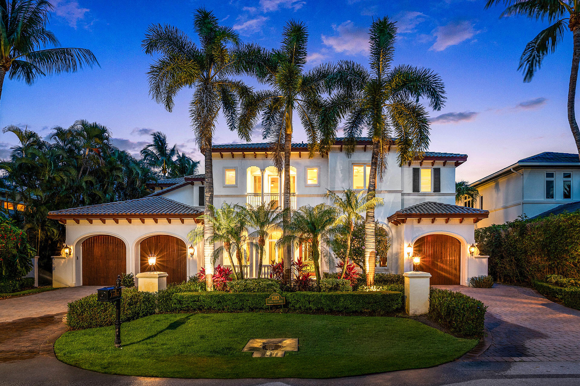 Positioned along the 15th fairway within the prestigious Royal Palm Yacht & Country Club, 1282 Sabal Palm Drive is a private golf course estate defined by timeless architecture, resort-inspired living, and a coveted southeast exposure that fills the residence with natural light from sunrise to sunset. Crafted in 2003 by Bloomfield Construction, the home spans approximately 6,068 square feet of thoughtfully designed interiors, blending elegant entertaining spaces with relaxed everyday comfort. Beyond the stately arrival, the residence unfolds with grand yet inviting proportions. Formal living and dining spaces are complemented by a butler's pantry and a beautifully designed gourmet kitchen featuring premium appliances, a center island, and seamless flow into the home's main gathering areas. The outdoor setting evokes the atmosphere of an exclusive private resort. Surrounded by lush tropical landscaping, the backyard centers around a spectacular beach-entry lagoon-style pool overlooking the manicured fairways beyond. A covered loggia invites year-round outdoor living with a built-in grill, al fresco dining areas, and multiple spaces for entertaining or quiet relaxation beneath the South Florida sky. Privately positioned, the grand primary suite serves as a luxurious retreat, complete with a spacious sitting room, a spa-inspired bath, and a private balcony offering tranquil golf course views. Five bedrooms, five full baths, and a three-and-a-half-car garage provide exceptional comfort and flexibility. Modern conveniences are seamlessly integrated throughout, including Savant home automation with iPad controls, natural gas, impact windows and doors, tankless water heaters, and a generator, delivering effortless living and peace of mind in one of Boca Raton's most prestigious enclaves.