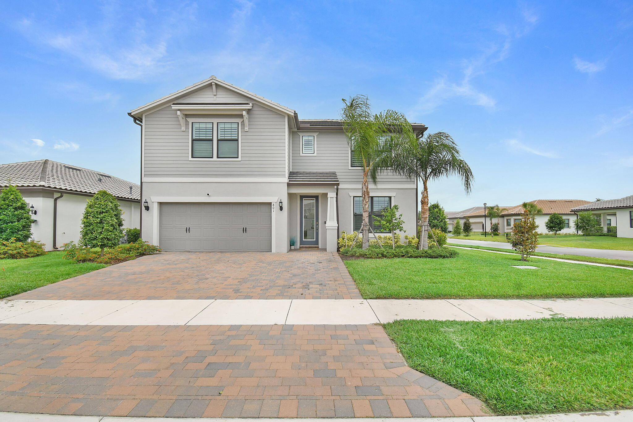Move-in ready and hard to find, this CBS 5bed, 4bath home is situated on a spacious corner lot. The designer kitchen features white cabinetry, quartz countertops, and modern finishes throughout. Thoughtfully appointed with elegant designer touches, this home offers plenty of space for a large family, including a generous upstairs loft ideal for a media room, playroom, or additional living area. The luxurious primary suite is conveniently located on the first floor. Main area pocket sliding doors open to a covered patio and a large, fully fenced backyard, perfect for entertaining and outdoor living. All new wood plantation shutters and new impact front door. Room for a pool! Enjoy resort-style community amenities-clubhouse, fitness center, lap pool and more!  Situated near 95 and turnpike