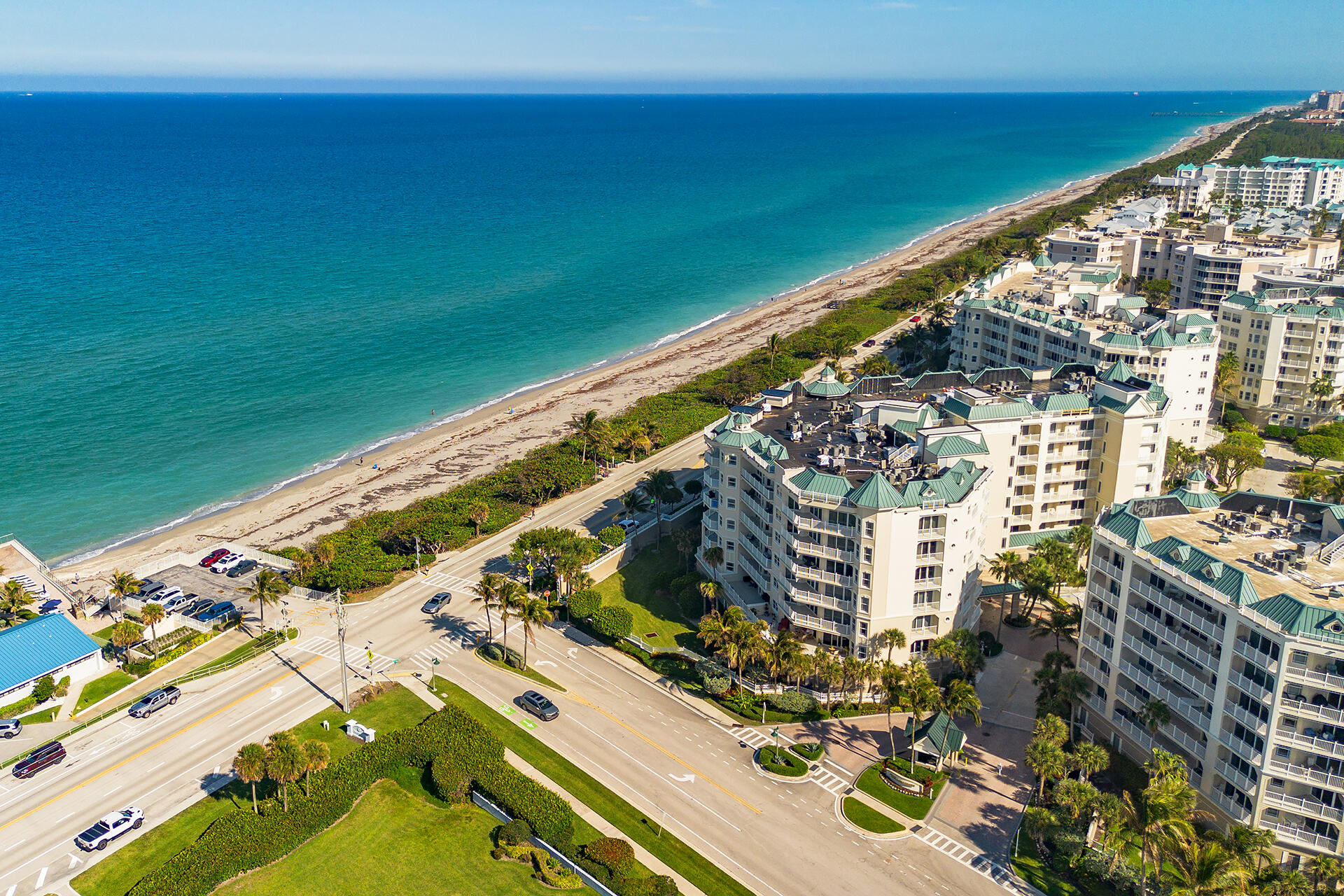 Jupiter Ocean Grande is among Jupiter's most prestigious oceanfront communities, delivering an exceptional coastal lifestyle. Residence 703 in Building One is Oceanfront and a rare offering, impeccably maintained and capturing sweeping ocean views from nearly every window and glass door. A flexible den adds versatility, easily functioning as a third bedroom, office, or media space. Inside, the home opens to a bright, spacious layout complemented by two private balconies—ideal for taking in sunrises and the refreshing ocean air. Additional features include a semi-private elevator entry with a private foyer, a storage locker, bike storage, and 2 assigned indoor parking spaces (#19 & #20). This gated community offers 24-hour manned security and a guard house for added peace of mind. Residents enjoy resort-style amenities including a fully equipped fitness center, game and billiards rooms, tennis and pickleball courts, and a beautifully designed pool with spa. A private walkway provides direct access to the beach, completing the ultimate oceanfront setting. Perfectly positioned, Jupiter Ocean Grande is just a short drive to Palm Beach International Airport, along with an array of fine dining and waterfront restaurants, scenic parks, world-class fishing, and endless recreational options. With its generous living space, ample storage, and seamless indoor-outdoor flow, this residence is ideal for both relaxed living and entertaining in style. Kitchen and Bathrooms staged to show potential remodeling ideas