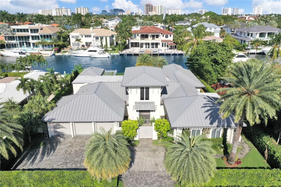 Spectacular one-story coastal modern home on one of the most exclusive waterways in Harbor Beach. Residence equipped with impeccable finishes, thoughtful interior design, 105 ft of water frontage on +/-140' wide canal, boat lift, and Azek composite dock. Eat-in kitchen with high end appliances, custom cabinetry and water views. Large master bedroom with vaulted ceilings, walk-in closet, dual vanities & soaking tub in master bath. Home built with NanaWall folding doors which seamlessly blend with the outdoor living area. Home also features lush landscaping, pool, spa, cabana bath, & outdoor summer kitchen with gazebo to enjoy the beautiful breezy days and nights. Private Harbor Beach Surf Club with 300 ft of beachfront & private marina membership available.
