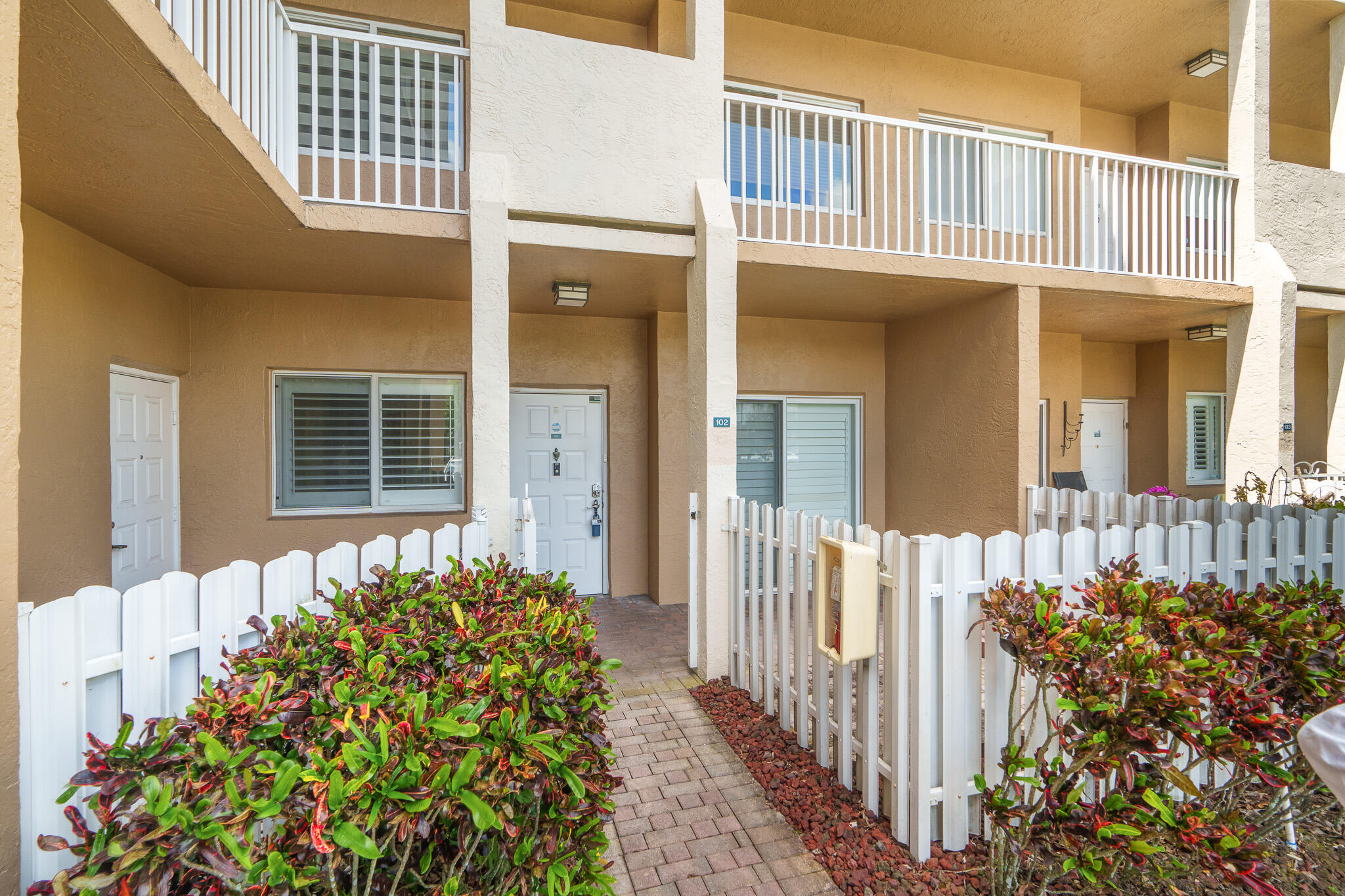 RARE, PET FRIENDLY 1st FLOOR lakefront "end unit" in Southampton with a coveted, private, secure Storage Closet. Park right in front of your condo! The autonomy of this condo is priceless. You'll love the little picket fence surrounding the front patio/garden area of your condo. Electric bills are gentle as you enjoy the insulation & security of Impact Windows & Doors "dressed" with Plantation Shutters throughout. The AC was installed in Jan. 2025, Water Heater June 2022, Appliances in Kitchen 2-3 years old & lightly used. The Hallway Bath offers a fantastic Hydrotherapy "Walk-In Spa Tub". Recently installed & barely used, this Hydro Therapy Walk-In Spa is unbelievable! Primary Bath offers a newer Bath Fitter Shower. Rec Lease Paid in Full conveys to Buyer! Expansive, serene water views!  ONLY 1st Floor Condos @ Southampton are permitted to have 1 pet, under 30 lbs. Association states "Over 55 Community"  At least 1 Resident/Owner must be over 55 Years of Age Association states "Min. Credit Score" 700 Association states "Min. 20% Down payment in Escrow Entire Time From Contract to Closing"