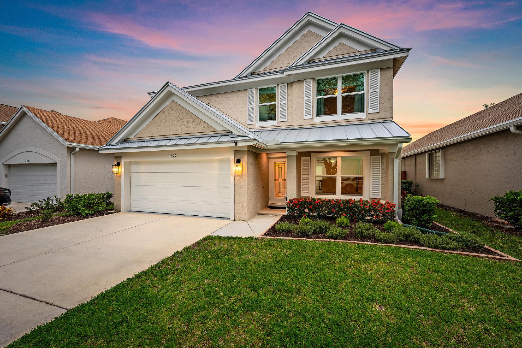 You are NOT going to want to miss this!! BRAND NEW METAL ROOF, COMPLETE IMPACT GLASS, 2022 A/C, 2026 INTERIOR AND EXTERIOR PAINT!   Remodeled Kitchen and Bathrooms! Luxury Vinyl Flooring!     All of these amazing features and yes, you are reading that price right! This is the LEAST expensive 4 Bedroom Home in all of Palm City!     The HOA fee is LOW at $350 / month and covers front and rear sprinklers, front lawn care and tree trimming, secure gated entry, a sparkling pool, tennis and pickleball courts and Xfinity Cable! As you approach this amazing home you are instantly greeted by the stunning exterior paint and brand new metal roof.  Enter and the home welcomes you with a Formal Living Room complete with large impact window overlooking the covered front porch.  The main level has been designed for effortless living with a Formal Dining Room, Kitchen with secondary Dining Space and sprawling Family Room all overlooking the most beautiful fully fenced back yard!     Your Kitchen has JUST been remodeled with Quartz countertops and a large farmhouse sink!  The colors are absolutely stunning and pair well with the bright white cabinetry and stainless steel appliances.  Upstairs you have 4 well sized bedrooms and a Primary suite with vaulted ceilings.  The windows in this home are astoundingly large, with wider and taller coverage than similar models.  Natural light immerses the home with beautiful views of the back yard from above.  Luxury Vinyl Plank Flooring upstairs provides for easy clean up and maintenance.  Renovated Bathrooms are both complete with shelving nooks and stone flooring in the Primary. The Primary includes a soaking tub fit for a Queen and a walk in closet a mile long!     The garage is deeper than most at ~22'5", accommodating longer vehicles or simply allowing more storage space!  The floor has just been refinished for you and the 2022 Air Conditioning System is complete with a blue light sanitizer and electrostatic filter! A lush back yard perfect for children and pets is completed by a large covered patio with extended concrete!     School starts soon, let's get your family into this amazing gated community, Palm Isles, so you can enjoy the sparkling pool and tennis courts before summer is over!  Palm City welcomes you with A rated, highly coveted Martin County Schools, a newly constructed The Patio at Palm City Place, access to Treasure Coast waters, beautiful beaches and more! 2 Minutes from the Turnpike and 5 minutes to I-95 makes for the most convenient commute.  You simply won't be disappointed in the VALUE the owners have provided for you with this home.     Don't wait! Schedule your private showing today and let's make this incredible home yours!