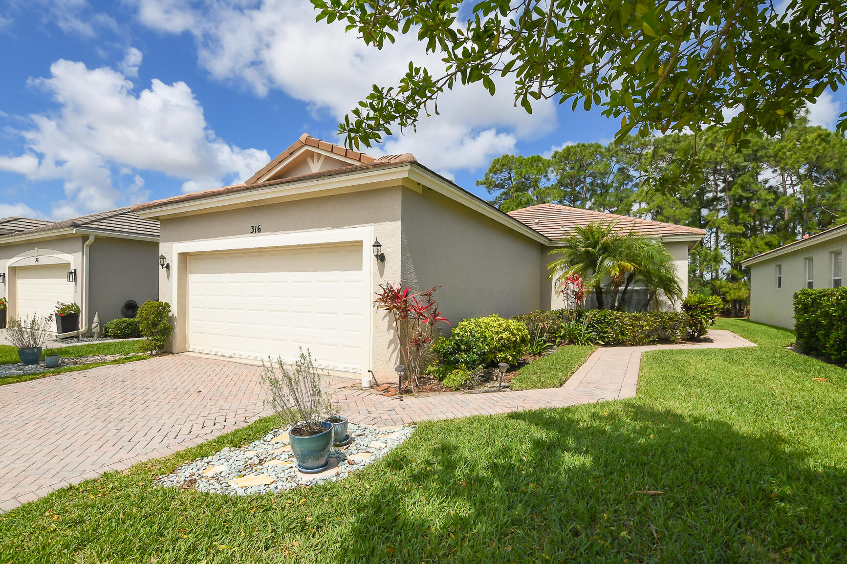 Located in the gated community of Lake Forest Pointe in the heart of St. Lucie West, this well-maintained home offers private outdoor living with no rear neighbors and a peaceful preserve/canal setting.  Enjoy a screened and tiled lanai with ceiling fan overlooking a fully fenced backyard—ideal for year-round outdoor living and entertaining.  Interior features a clean, move-in ready layout with neutral finishes throughout. The kitchen includes wood cabinetry, granite countertops, stainless steel appliances, and a functional design with adjacent dining space. Bright living areas with tile flooring and natural light create an open, comfortable feel.  Bedrooms offer updated flooring and ample storage, including a walk-in closet. Home is well cared for and ready for immediate occupancy.   Lake Forest Pointe is a secure, gated community featuring a clubhouse, resort-style pool, cabana bath, and beautifully maintained common areas.   Ideally located near shopping, dining, and major highways in St. Lucie West, offering both convenience and lifestyle.