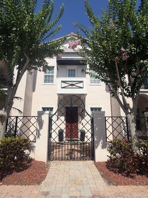 Location & Luxury!   Super low hoa, on a prime lot, spacious w/3 full baths, front gated courtyard & an interior private courtyard, 10' ceilings 1st floor & 9' 2nd floor, great room, 42" maple wood kitchen cabinets w/granite counter tops & backsplash, master bedroom features double door entry, sitting area, large walk-in closet w/luxury wood built-ins, balcony, master bath w/dual vanity, jet tub, linen closet, large 2nd floor loft separates the master bedroom from the guest bedroom w/full ensuite bath & walk-in coset, walk-in laundry room on 2nd floor, impact windows, large 2 car garage with no homes in back offering privacy, community heated pool, tot-lot, gym, easy 2 minute access to I-95, 10 min drive to beach, patrolled night security.  Investors no wait period - rent immediately.    Chrystal chandeliers/lighting & tv's & tv mounts are NOT included in sale of home.   Owner/agent.