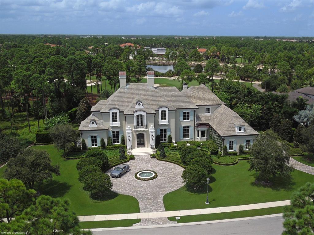 Outstanding five bedroom two story residence situated on an acre of property. All major rooms have expansive views of the golf course. This country French style estate has stunning details, throughout ,wide oak and limestone floors, crown moldings, smart technology, gourmet open kitchen with Carrera marble and onyx surfaces. Wonderful informal family room with vaulted ceilings that lead out to the outdoor living area, complete with summer kitchen. Adjoining is a privately located one bedroom guest house. The main level includes a formal living room with fireplace, a spacious dining room, handsome wood paneled office library, den and spacious guest bedroom with bath ensuite. A grand soaring stairway or private elevator will take you to the second level which leads you to a spectacular master suite with dual bathrooms, steam shower, Jacuzzi, exercise room, a sitting room with fireplace. In addition are two guest bedrooms with baths ensuite. Lush gardens surround the pool and loggia areas and lend itself to enchanting outdoor living. Four car garage. This extraordinary home is located in a most serene environment which offers the highest level of amenities in this low density private golf club community.
