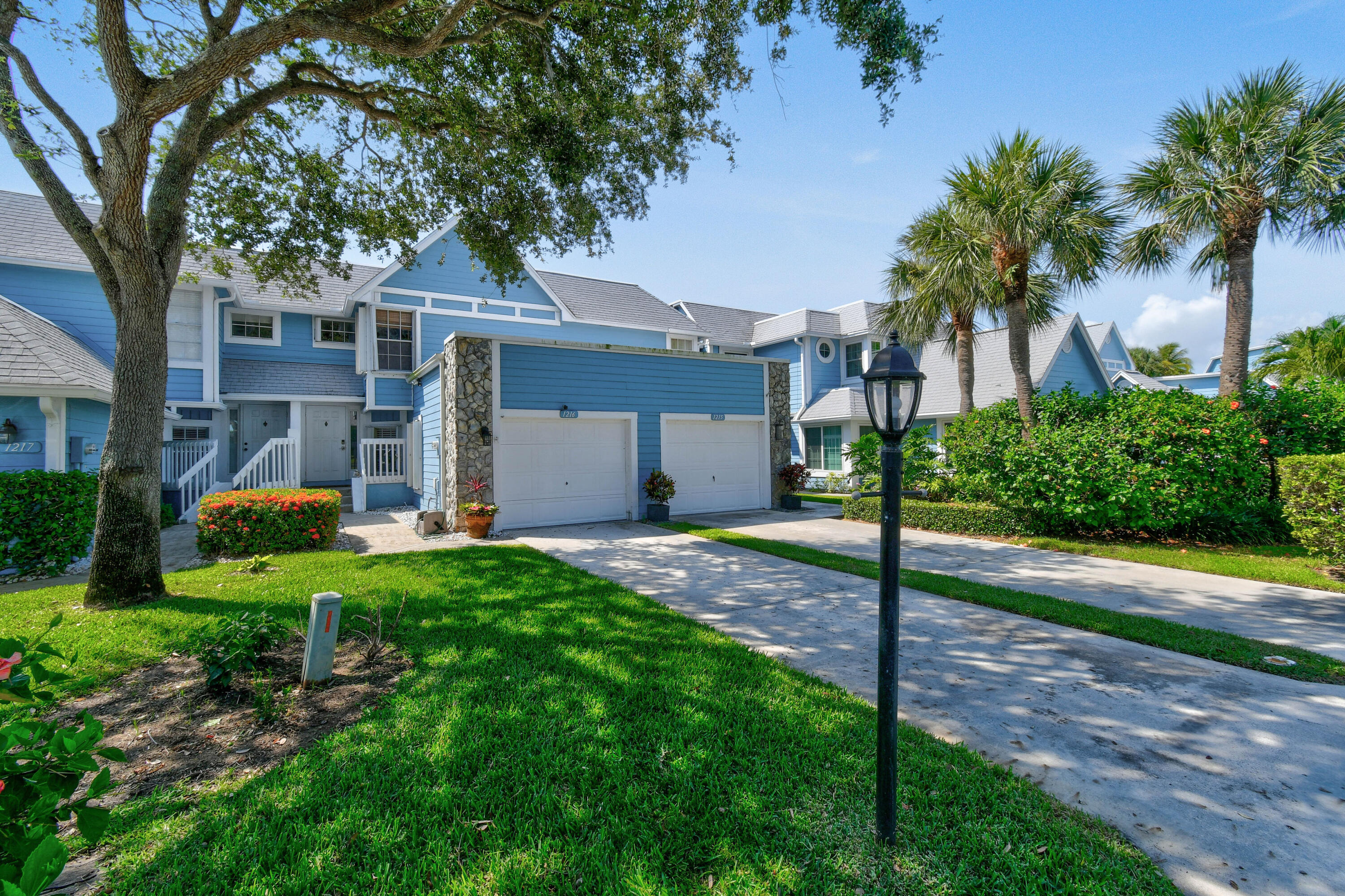This 2 level townhome, located in a small gated community just a short walk from the beach, is available off-season 2025. The townhome features both bedrooms on the second floor, along with a great room that includes sliding doors opening to a lovely lakefront deck. For your convenience, the townhome has an attached 1 car garage. The primary bedroom is furnished with a king-size bed, and the secondary bedroom has a queen-size bed. Residents of this community can enjoy a spacious pool, tennis courts, and the benefit of on-site management. Its location offers easy access to the beach and a nearby shopping center. Additionally, it is close to a variety of excellent restaurants and golf courses. Sports enthusiasts will appreciate the proximity to Roger Dean Stadium.