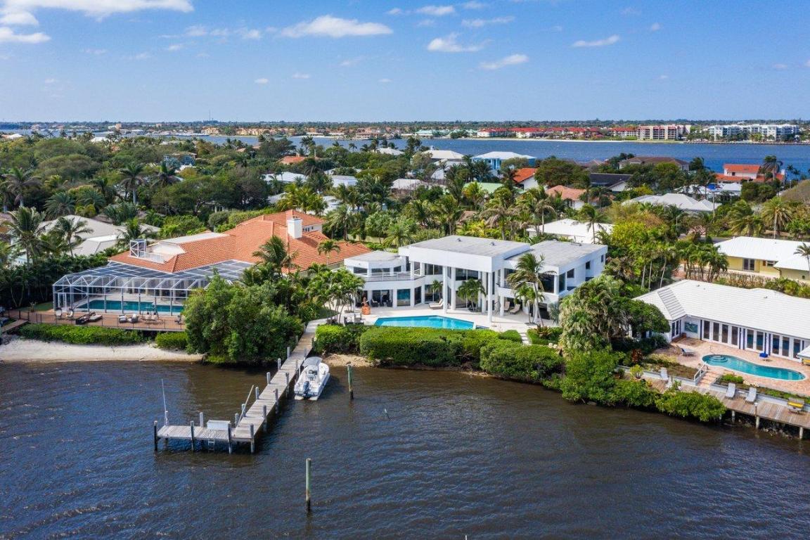 This masterfully designed modern estate is the perfect property for living the waterfront lifestyle! Easily enjoy your yacht, jets skis, and all water sports from your private dock with easy access to the Boynton Inlet. Each room in this 5 bedroom, 5.5 bathroom home offers spectacular views of the intracoastal waterway. The spacious, open floor plan is bathed in natural light that pours in from the running walls of glass that blends the outside with the inside and brings the entire home to life. The home's covered patio features an outdoor kitchen and lakeside pool and spa that is accessible through the impact glass sliders in the living room and kitchen.  An oversized master bedroom provides the ultimate retreat with a sitting room, marble bathroom, and generous closet space. Hypoluxo Island offers the luxury of oceanfront living with the privacy and charm of a small town that is becoming increasingly valuable in today's market.