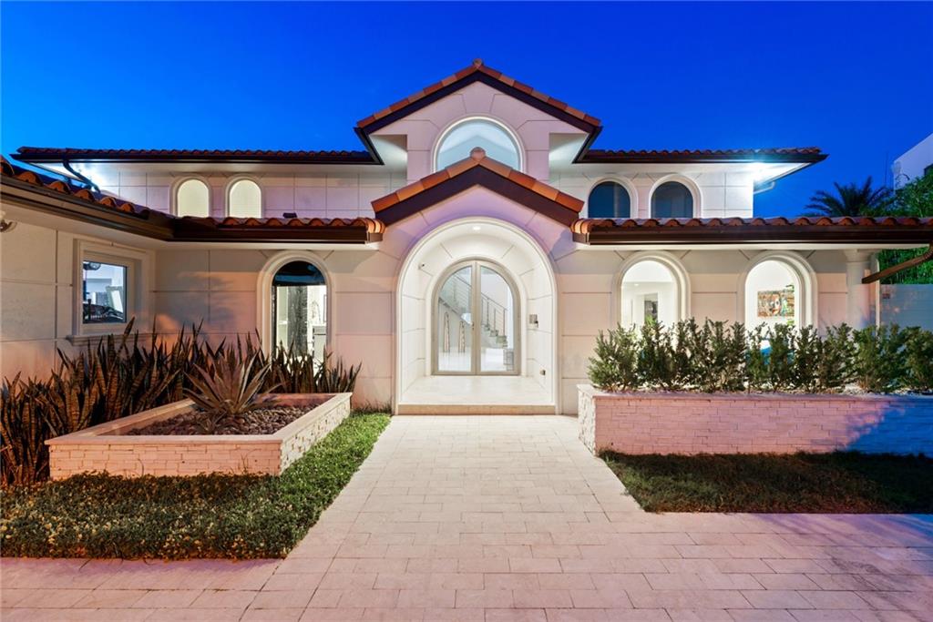 What a fabulous contemporary 5 bedroom and 5 bath home. Totally updated throughout. High ceilings, impact windows and doors. Gourmet kitchen with all stainless steel appliances. Elevator, outside summer kitchen. 110 feet on deep water with beautiful views of the intracoastal one from the point Plus a boat lift. This is a must see, 1 Mile to the beach.