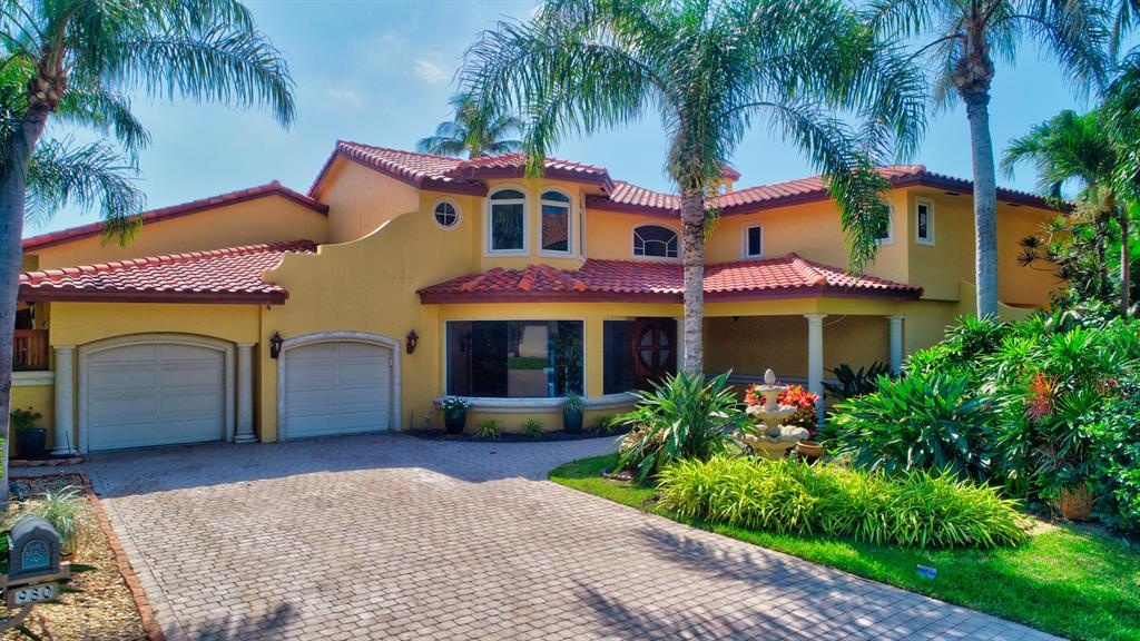 Spectacular direct Intracoastal point lot in Tropic Isle with gorgeous SE views and 125 feet on the water! This neighborhood is a true boater's paradise and this 4 bedroom 5 bath home does not disappoint. As soon as you walk through the door you're greeted with expansive views of the Intracoastal and the gorgeous outdoor living space. This home is perfect for entertaining and features a large eat-in kitchen with island and walk-in pantry, large family room with custom onyx bar with access to the pool/patio, large living room with fireplace and soaring ceilings all overlooking the water. The first floor also has two private bedrooms with ensuite bathrooms each with their own patio, a den/office and a large laundry room. The upstairs has 2 bedrooms and an office and features a double-door entry into the master suite which is complete with an oversized bathroom with his/her sinks, new shower, large soaking tub and large walk-in closet. The office has a balcony overlooking the pool/Intracoastal and also features a washer/dryer hookup and spiral staircase with quick access to the first floor. The first floor has beautiful polished marble floors and the stairs/second floor have hardwood flooring. Other features included impact windows, tall French doors leading to the pool/patio from the living room, kitchen and family room, 2 year old roof, newer dock and boat lift, solid wood interior doors, outdoor gazebo and plenty of storage.  Ideally located near a variety of shops including Whole Foods and Trader Joes, close to Downtown Delray's Atlantic Avenue and just over the bridge you'll find Delray's award winning beaches.