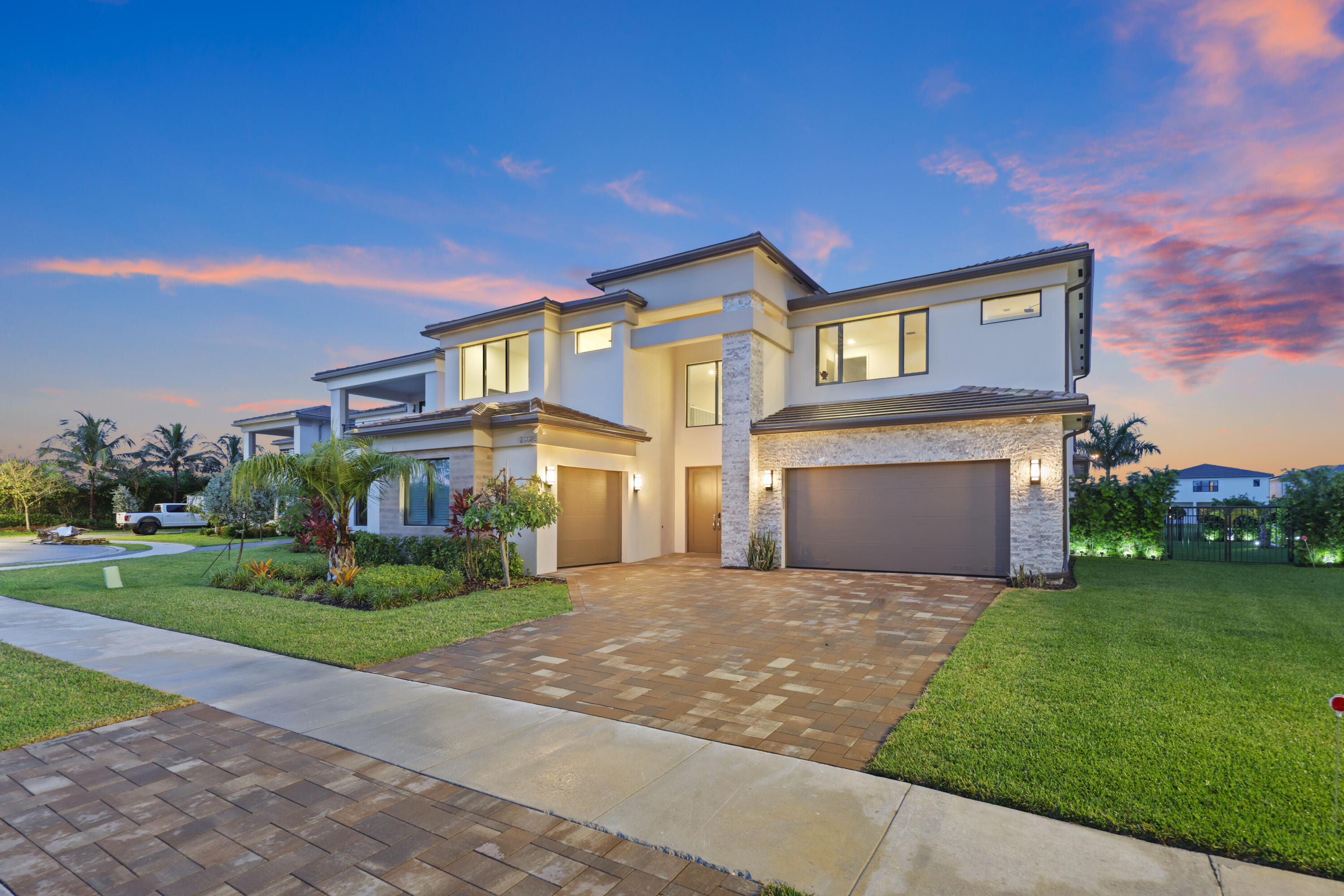 Better than new! Nestled on a quiet cul-de-sac in sought-after Lotus Palm, this exceptional waterfront residence sits on one of the largest and deepest backyard lots in the community, offering plenty of room to build a horizontal private pool. Featuring 5 bedrooms, 5.5 bathrooms, a private den, loft, movie room/flex space, and a 3-car garage, this beautifully designed home includes a desirable first-floor primary suite. A grand foyer with soaring ceilings creates a stunning first impression. Oversized Porcelain flooring. Gourmet chefs Gas kitchen with a large center island great for entertaining. Enjoy resort-style amenities including a new clubhouse, tennis and pickleball courts, restaurant, and fitness center. No country club fees. Make this your new Florida forever home.