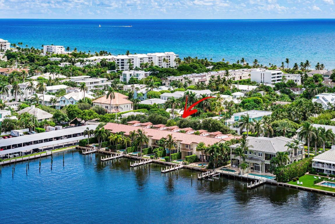 A true haven for boating enthusiasts, this Beach Area townhome offers 30 feet of direct Intracoastal frontage and a 40-foot dock accommodating vessels up to 55 feet. Spanning 4,654± square feet, the residence blends Mediterranean-inspired architecture with modern refinement, showcasing marble and wood floors, graceful archways, intricate moldings, and warm design accents. Light-filled interiors flow from the formal living room to the expansive great room, where French doors open to a private pool patio framing breathtaking sunset views over the Intracoastal. The chef's kitchen is beautifully reimagined with custom cabinetry, a breakfast nook, Wolf gas range and convection steam oven, SubZero refrigerator, and Miele dishwasher. Upstairs, the primary suite is a true sanctuary with a sitting area, balcony capturing sweeping water vistas, and a spa-inspired bath with jetted tub, frameless glass shower, and dual vanities. Two guest bedrooms, a guest bath, and laundry complete the second floor, while the first includes a versatile family room with full bath and a two-car garage. With a new roof, impact-glass windows, this exceptional home offers peace of mind and a coveted Intracoastal lifestyleall just minutes from Delray Beach's famed Atlantic Avenue.