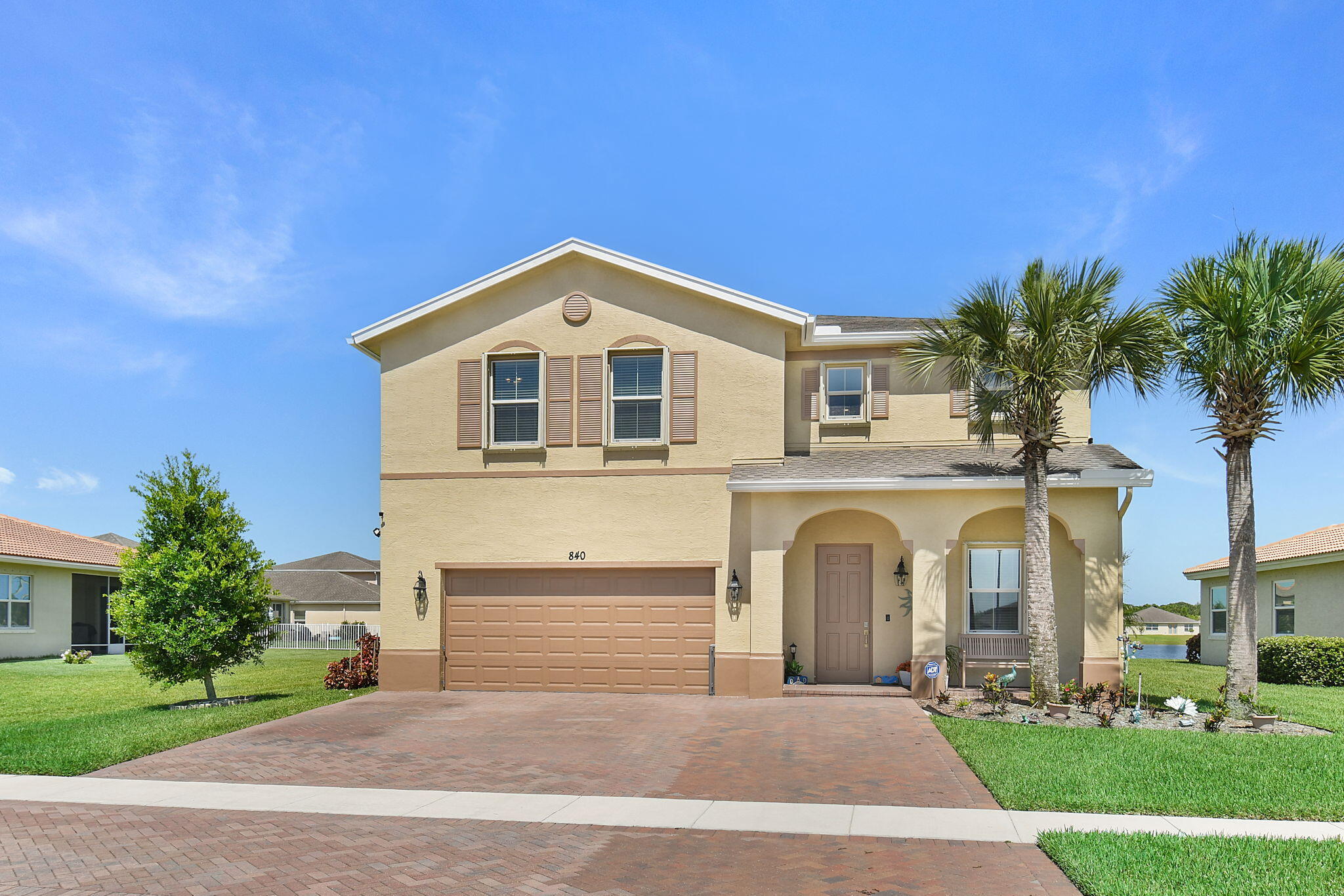 Beautiful and meticulously maintained lakefront 4BR/2.5BA home in the desirable gated community of Bent Creek. Relax on the east-facing covered patio overlooking the peaceful lake, or unwind in the covered pergola at the water's edge. The fully fenced backyard is perfect for kids and pets. The kitchen features granite countertops, stainless steel appliances, a large island with bar seating, and opens to the living space. A welcoming foyer enhances the home's spacious feel. New luxury vinyl plank flooring installed in 2023. Full CBS construction with accordion shutters for peace of mind. Home exterior painted 2025. Bent Creek offers a resort-style pool, kiddie pool, basketball, tennis/pickleball courts, clubhouse, and a convenient location near I-95, turnpike, downtown, and the beaches.