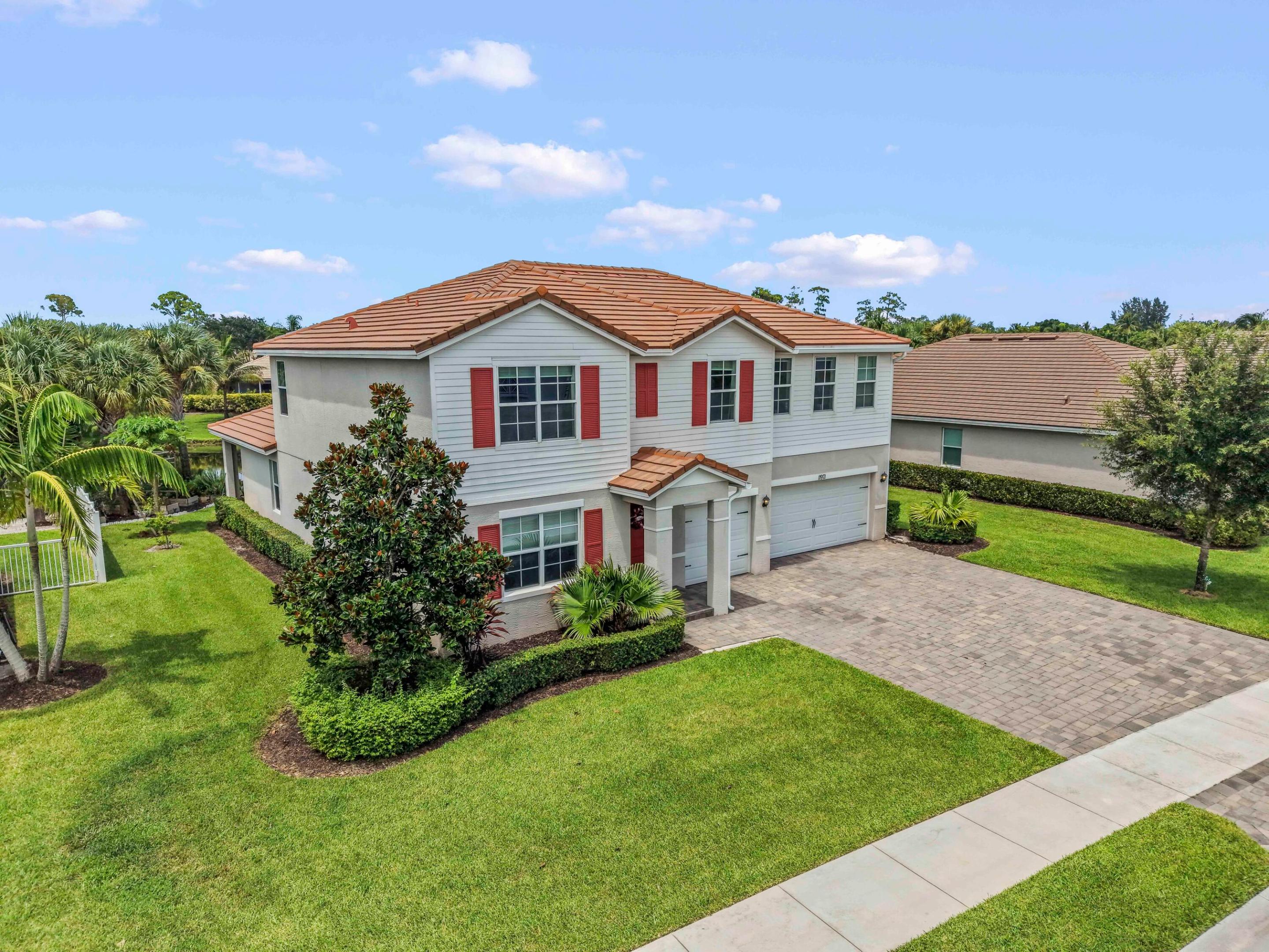 11971 Cypress Key Way delivers impressive space, modern comfort, and inviting curb appeal in the heart of Royal Palm Beach. Built in 2017, this two-story residence offers 5 bedrooms, 3.5 bathrooms, plus a den space which can easily be used as a 6th bedroom, nearly 3,700 square feet of living space, and a 3-car garage. A wide paver driveway, vibrant landscaping, and a welcoming covered entrance create a polished first impression.  Inside, the expansive layout provides plenty of room for everyday living, entertaining, and working from home. Generously sized gathering areas flow naturally throughout the main level, while the kitchen serves as a comfortable central hub for preparing meals and connecting with guests.  The five-bedroom plus den design offers excellent flexibility for overnight visitors, a private office, a media room, or a playroom, while the spacious first floor primary suite provides a peaceful place to unwind.  The waterfront outdoor area extends the home's entertaining possibilities, offering space to relax, dine, and enjoy the South Florida lifestyle. Located in the desirable Cypress Key community, this home combines a newer construction feel with convenient access to shopping, restaurants, parks, A-rated schools, and everyday necessities. With its substantial floor plan, versatile living spaces, and three-car garage, this Royal Palm Beach residence is ready to complement a variety of lifestyles.