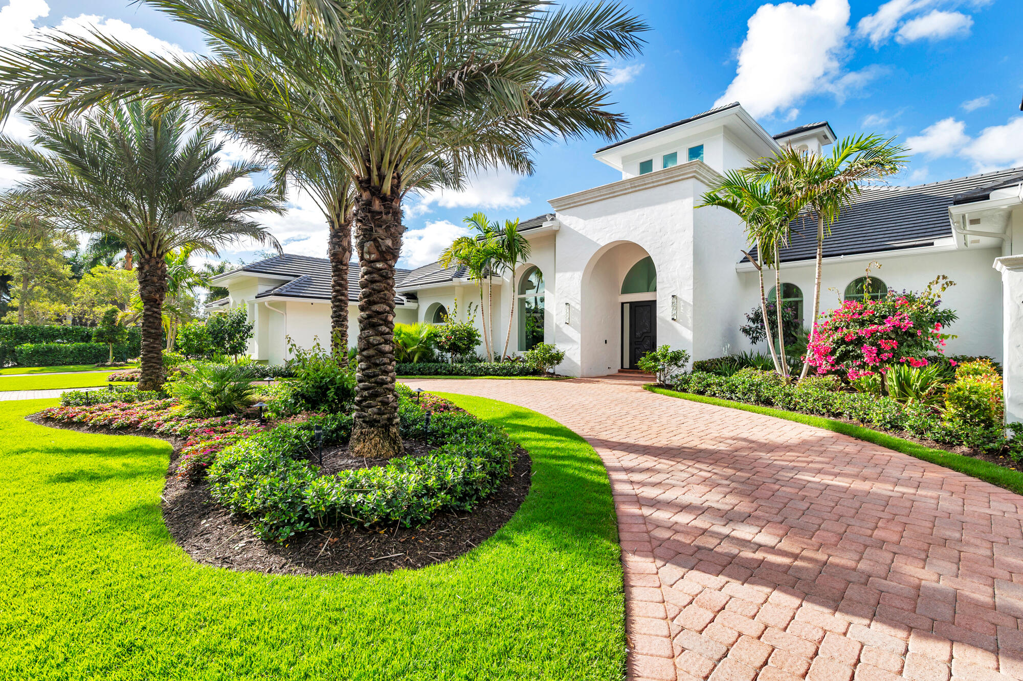 Located within the prestigious Kensington neighborhood of the Palm Beach Polo & Country Club, this exceptional one-story estate presents a sophisticated blend of scale, comfort, and modern design across more than 6,700 square feet. Thoughtfully curated interiors feature 4 spacious bedroom suites, 2 private offices, 4 full baths, and expansive living spaces enhanced by soaring ceilings, abundant natural light, and newly installed marble flooring throughout.  Designed for both refined entertaining and effortless everyday living, the interiors transition seamlessly to beautifully landscaped outdoor spaces with covered terraces, multiple lounge and dining areas, and a newly completed resort-style pool and spa. A fully equipped outdoor kitchen further elevates the setting, creating an ideal backdrop for year-round gatherings and relaxed outdoor living. Additional highlights include impact-rated windows and doors, a brand-new roof, whole-house generator, and an oversized four-car garage with generous storage space. Positioned within one of Wellington's most sought-after gated communities, celebrated for its premier equestrian lifestyle and privacy, this turnkey residence offers an exceptional opportunity within Palm Beach Polo.