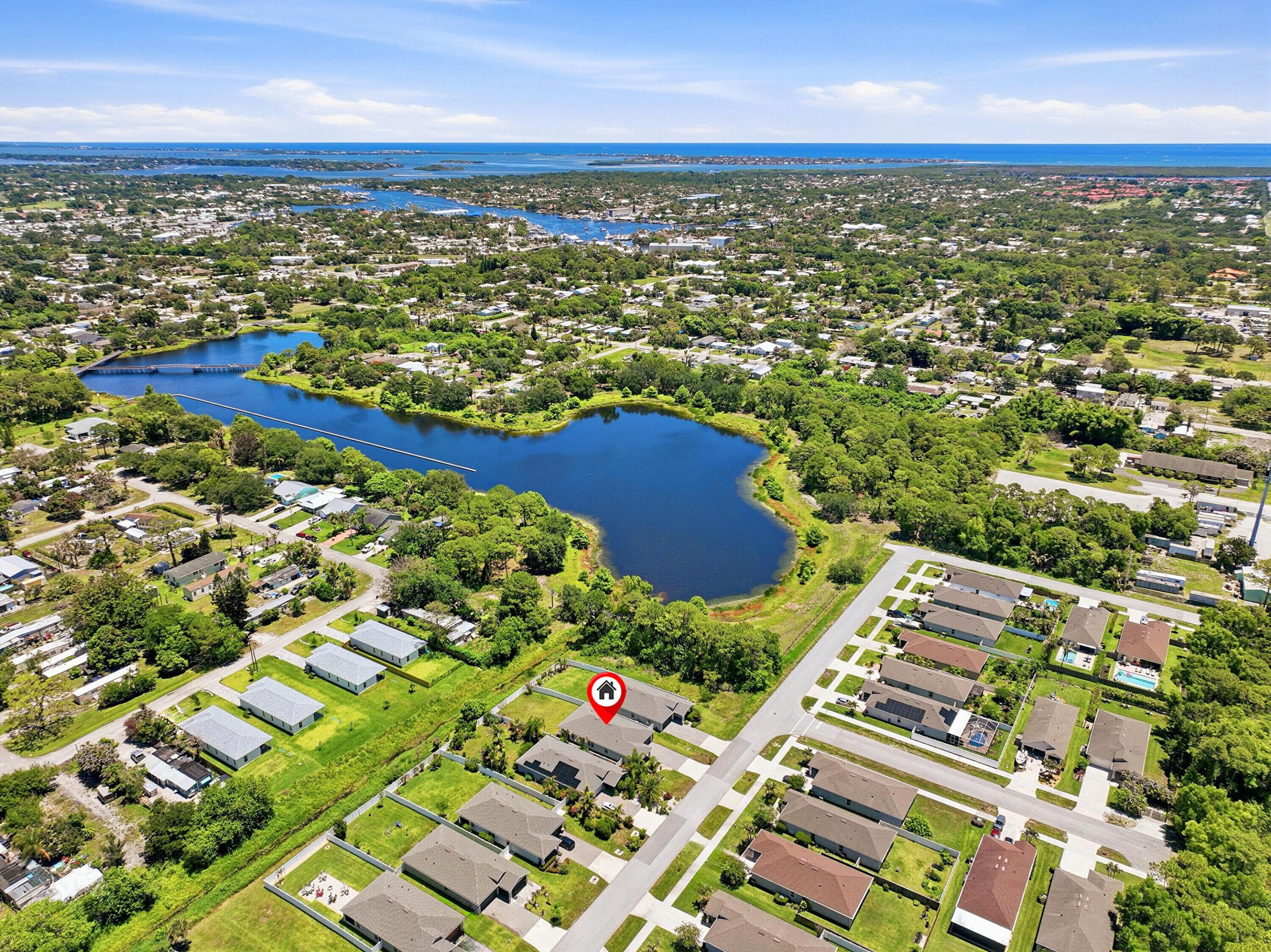 Stuart, known as the "Sailfish Capital of the World," offers a relaxed coastal lifestyle. Discover this meticulously maintained, 5 year new single-family home in the heart of desirable Port Salerno area of Stuart. Built in 2021, this 4-bedroom, 2-bathroom residence offers approximately 1,730 SF of comfortable living space on a generous 8,712-square-foot lot complete with a 2-car garage and brick paver driveway. This property stands out due to the thoughtful owner upgrades that elevate it beyond standard new construction. The custom gourmet kitchen represents a significant investment in functionality and style.  Only the best here, Custom Cabinets with pull out drawers (I love those and in the pantry),  KitchenAid appliances, stunning quartz waterfall countertops and chefs vent cont'd. over the stove. The Hunter Douglas blinds throughout provide a polished, uniform look. The living room sliding door leads to a picturesque rear yard and brick paver patio.  All four bedrooms are generously sized and located on the main level, providing flexibility for guests or a home office. The primary suite offers a peaceful retreat with a fabulous walk in closet with built ins as well. The impact windows and doors deliver both protection and insurance savings—critical in today's Florida market! Located 1 home from the Great Salerno Basin which is fed from Manatee Pocket!  It's a spectacular area, old world Florida fishing village.  Stuart offers world-class fishing, boating, and waterfront dining. This home is conveniently situated near the St. Lucie River, beaches, parks, shopping and restaurants. Enjoy easy access to downtown Stuart's vibrant arts scene, farmers markets, and marinas.  Priced to attract discerning buyers seeking quality construction in a prime Treasure Coast location.