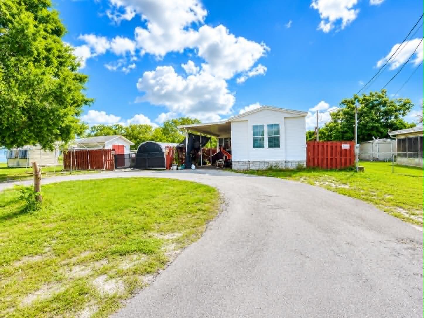 Imagine spending your mornings cruising the water, afternoons fishing, and evenings relaxing on your back deck. This 2-bedroom, 2-bath single-wide offers Lake Okeechobee access and includes a covered boat dock, making it the perfect retreat for anglers, outdoor enthusiasts, snowbirds, or anyone seeking affordable waterfront living. Enjoy easy access to some of Florida's best fishing and boating opportunities right from your backyard. Whether you're looking for a weekend getaway or a place to enjoy the lake lifestyle year-round, this property offers a unique opportunity to enjoy life on the water. Who's ready to trade traffic for lake life? Virtual Staging Disclaimer: Some images may include virtual staging and/or enhancements for illustrative purposes and may not reflect the property's current condition. Buyers should verify all features through personal inspection.