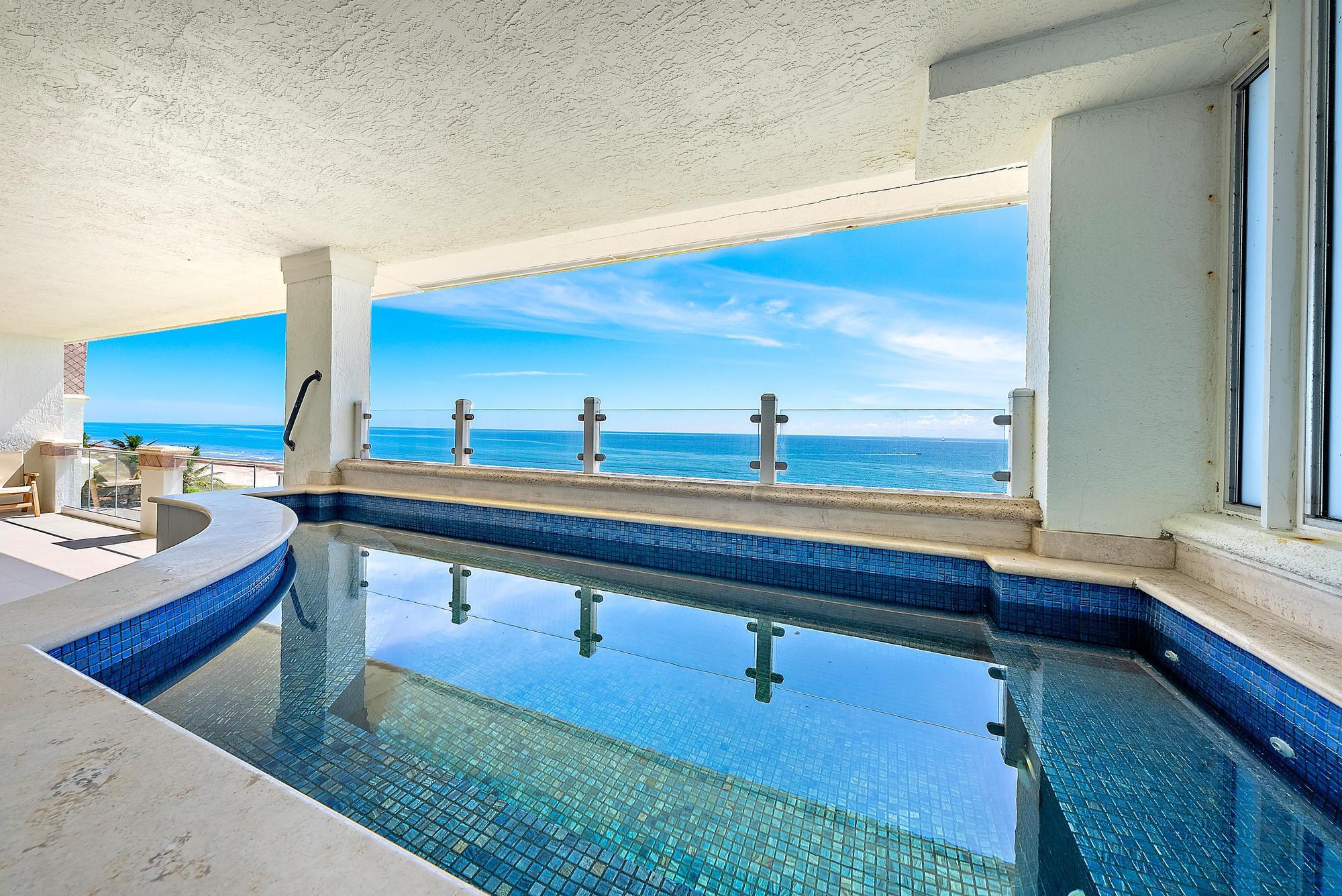 Private Penthouse Oasis with Sweeping Ocean Views. Elevate your lifestyle in this exquisite fourth-floor penthouse at the exclusive Athena, accessible by your own private entry and elevator. This coastal residence offers just under 4,000 square feet of single-level living, showcasing unobstructed, panoramic views of the Atlantic Ocean from every room. Designed with sophistication in mind, the 4-bedroom, 4-bath layout features a spacious split-bedroom floor plan, full-impact windows, and a grand great room. Entertain effortlessly in the formal living area, highlighted by a custom Italian porcelain feature wall and a sleek wet bar. The chef's kitchen is a culinary masterpiece, outfitted with quartzite countertops and top-tier Bosch, Sub-Zero, and Thermador appliances. This rare offering ... combines refined luxury, comfort, and unmatched oceanfront living just steps from the sand.