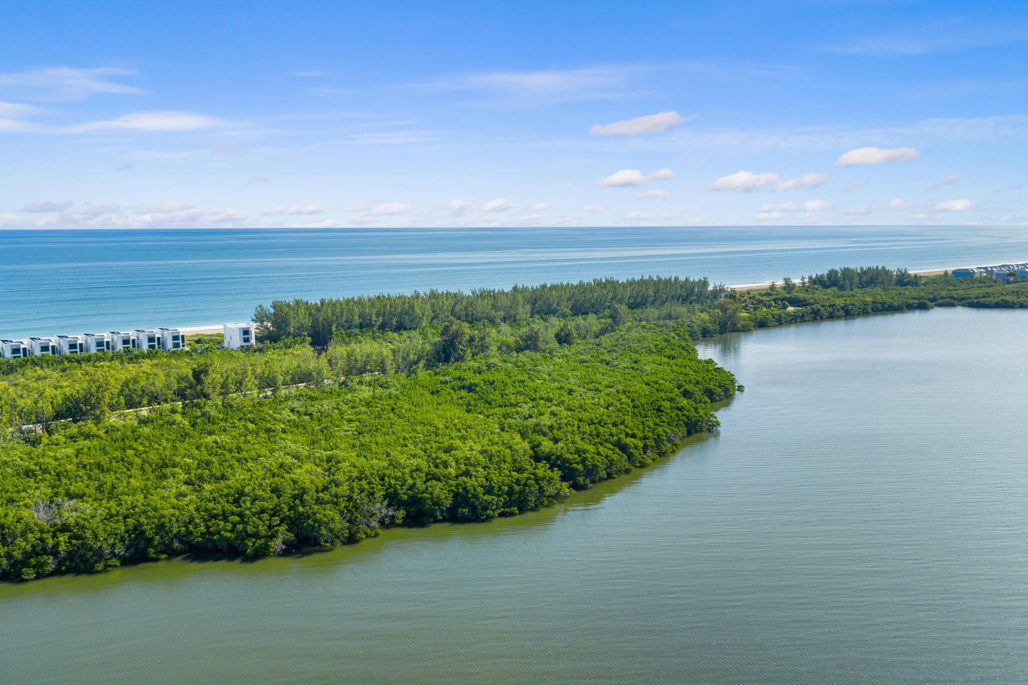 Rare opportunity to own a true ocean-to-river estate with 2 plus acre lot offering unmatched privacy and exclusivity. This exceptional parcels spans from the Atlantic Ocean to the Intracoastal Waterway, providing both sunrise and sunset water views. No HOA and no neighboring properties create a secluded setting ideal for a private estate. Property features a private entry directly from State Road A1A and offers the potential for private riverfront dockage, subject to permitting. Enjoy direct beach access, boating convenience, and the freedom to design and build without association restrictions.  An adjoining 2.65 acre lot (MLS # R11149796) can be purchased in addition to this lot for $7,000,000 with both lots totaling 5.3 acres.