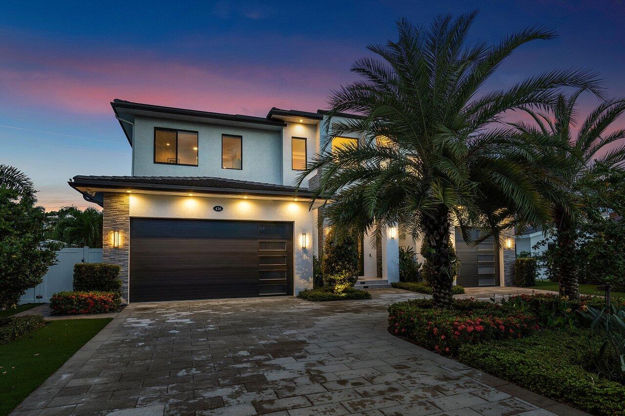 A truly special home! This recently built home shows like brand new, with a spectacular open floorplan featuring five-bedroom suites, including a detached pool house. Designed by a locally renowned architect, and built by East Boca's #1 builder, the home's first floor features living, dining, kitchen, media, office and gym with a three car garage. Custom upgrades include a wine wall feature, butlers pantry, car charging ports, elevator and summer kitchen. The second floor features a large secondary living space (complete with bar), and four ensuite bedrooms. Each oversize bedroom has it's own private bath and walk-in closet. The primary bedroom is a cozy and comfortable retreat, with a contemporary bathroom, large closets,  two water closets, and a large balcony overlooking the pool. Outdoors, you'll find an covered loggia with automatic roll-down screens, a saltwater heated pool  and spa, and lush tropical landscaping accented with artificial turf for minimal maintenance.  The detached secondary is perfect for guests, in-laws, or a secluded office or studio. All upgraded mechanicals, including on-demand gas hot water heater, three air conditioners, elevator,  and a  whole house liquid cooled generator! Fully built out closets, electric shades and so much more. Ready to move-in!