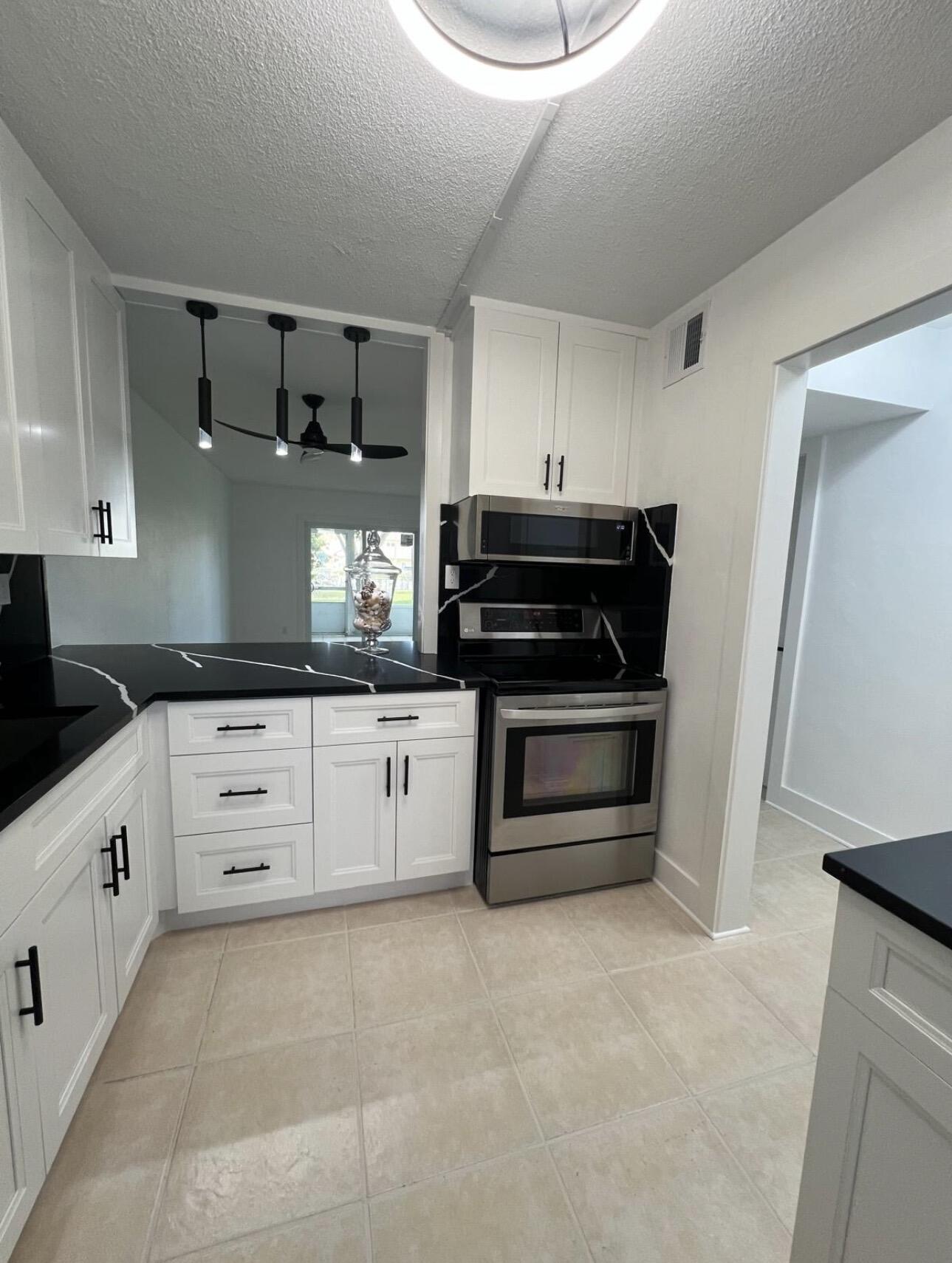 Welcome to this Beautiful & Tastefully remodeled Condo in the Luxurious & Pristine 55+ Community of Lake Clarke Gardens in the Heart of Lakeworth. Conveniently located near shops, restaurants, supermarkets, I-95 & more. This inviting unit is on the 1st floor & offers comfortable living, a beautiful brand new kitchen, wood cabinetry, a gorgeous Quartz counter top, new light fixtures, newer appliances, new doors & sliding doors, new paint through out, new ceiling fans, central A/C is less than 1 year old, walking closet in master bedroom, Jack & Jill bathroom & more. Enjoy the extra large screened porch & the serene garden views. HOA fees include, Building insurance, Cable, Internet, Water & Trash and an array of  amenities. Another plus is the Covered Parking within steeps from your door.   Amenities include Suffleboard, Bocce Ball, 2 Heated Swimming Pools, Billiard Room, Cards Room, Fitness Center, 2 BBQ areas, Putting Green, Library, Shuttle Bus and more. Make your appt today and come see this unit to appreciate all the details and make it yours. For sure it is a Must See!