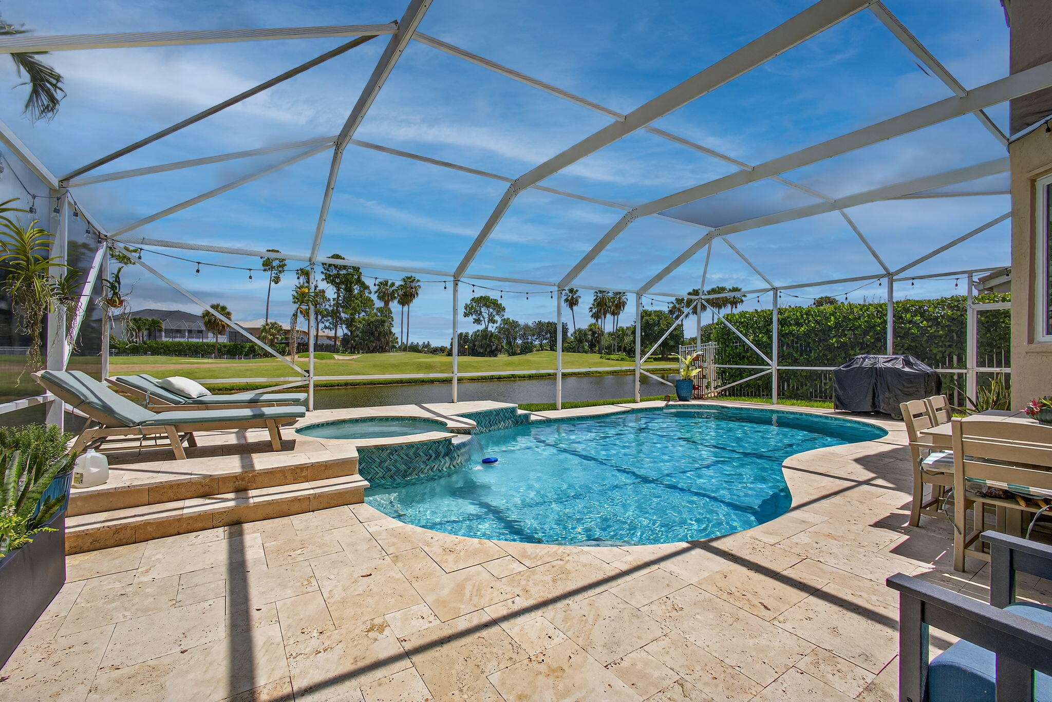 Fully updated 4-bedroom pool home on the 10th hole of Madison Green golf course. Every major element has been renovated — kitchen, baths, flooring, and windows. The kitchen features charcoal cabinetry, quartz waterfall island, and stainless appliances. All bathrooms are fully redesigned with quality finishes . Impact doors and windows. New travertine pool deck and pool tile. The primary suite includes a large bedroom, updated spa bath, and separate sitting area that works perfectly as a home office or gym. Two additional bedrooms upstairs share a Jack and Jill bath. A first-floor bedroom works as a guest room or office. Out back: screened pool and spa with golf course and water views. EV charger in garage · Video security system · HOA includes internet and cable