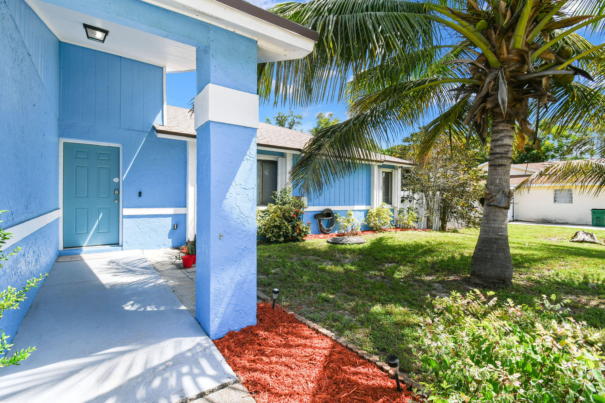 Welcome to this beautifully updated 3BR/2BA home tucked away in a quiet, no-HOA neighborhood. Inside, you'll find an open, airy layout w/vaulted ceilings, tile flooring, and a desirable split-bedroom design. The kitchen offers white cabinetry, granite countertops, stainless steel appliances, & a breakfast bar—perfect for everyday living or entertaining. The primary suite features a charming sliding barn door, tile and new shower & vanities.  The 2nd bath has been freshly updated as well featuring tile flooring & a new vanity. Recent updates include a 2024 roof w/a transferrable warranty, 2024 A/C, 2021 water heater, new interior & exterior doors & paint, & a storm-rated French door opening to the covered patio. The 2-car garage offers a washer, dryer, & sink for convenience. Outside you are greeted w/ a fully fenced ¼-acre lot, perfect for a pool, garden, or play space, complete w/avocado and coconut trees. Conveniently located near Crosstown Pkwy, I-95, US-1, shopping, and schools. This home is easy to love & easier to call your own!