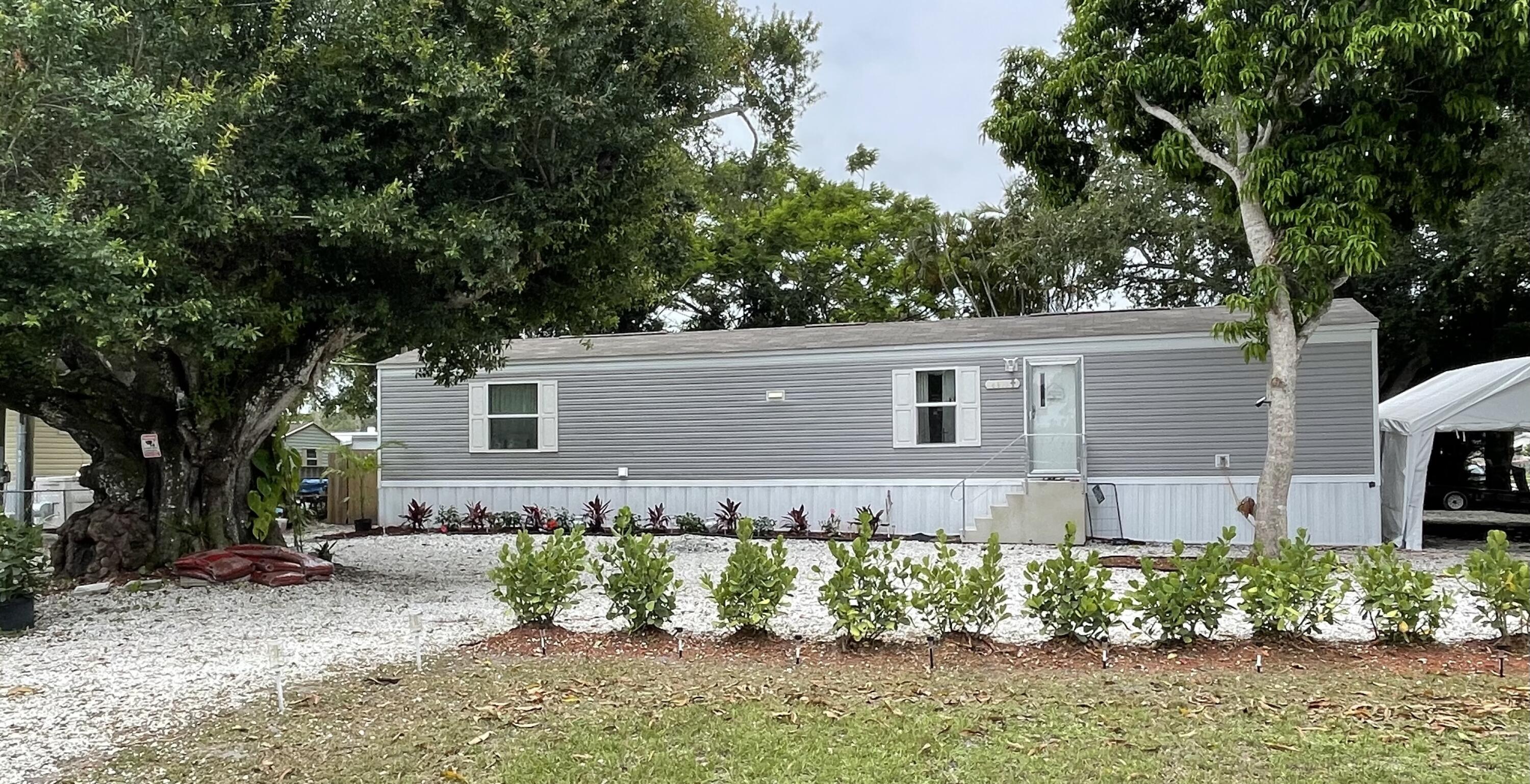Come take a look at this 2024 barely lived in 2/2 Mobile home on a corner lot and ''you own the land!''  Home also still has home warranties. Home has upgraded kitchen appliances, larger kitchen sink and new ceiling fans. Lights and Nest can be controlled by Alexa. Very close to the Treasure Coast Airport and a short drive to the beaches.