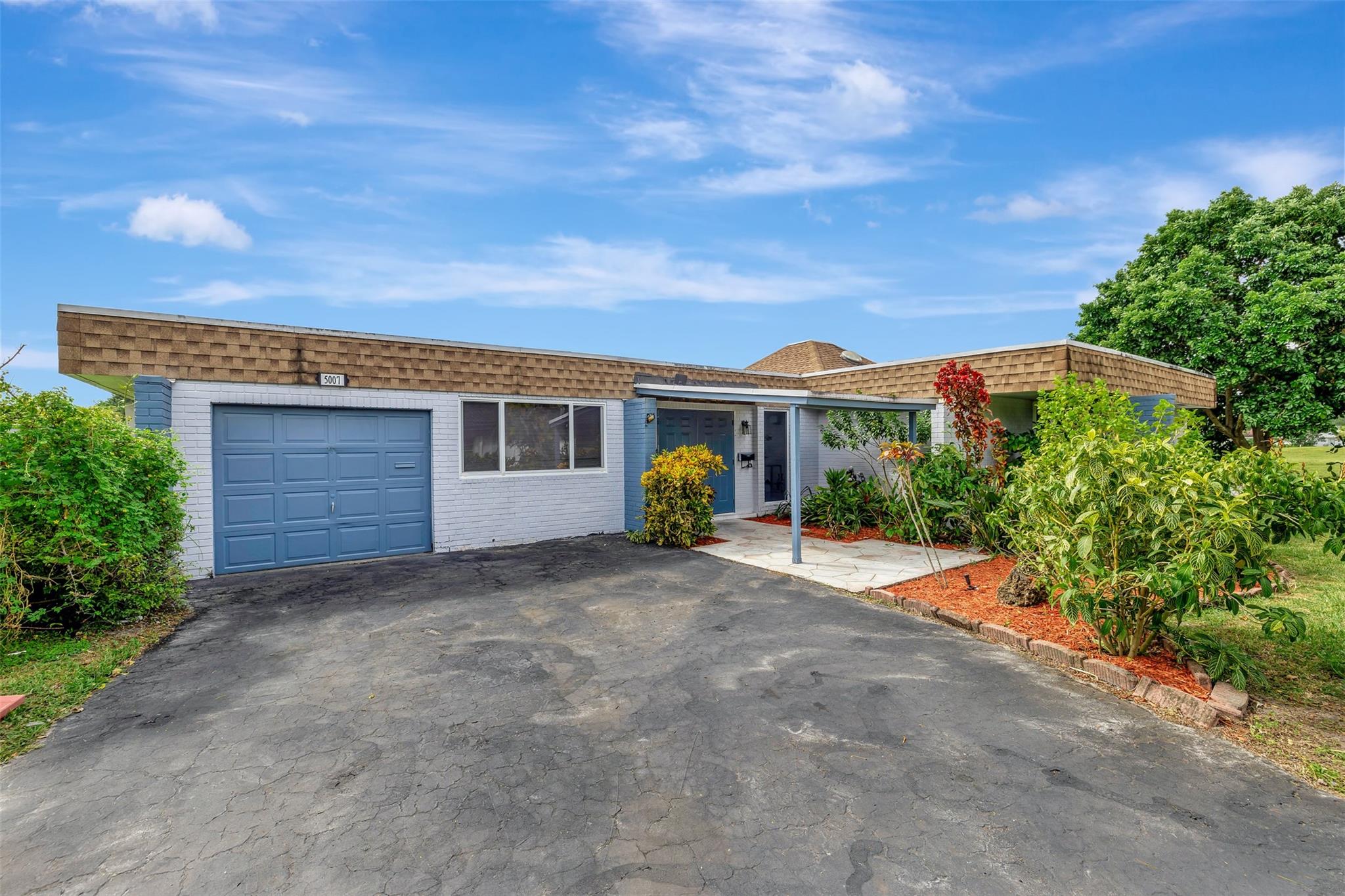 Beautifully renovated 3/2 with garage (and bonus storage room) in Woodlands! Located on a quiet cul-de-sac. Open floor plan boasts floor to ceiling IMPACT WINDOWS AND SLIDING DOORS allowing for an abundance of natural light. NEW LED recessed lighting throughout the home. AC from 2016. Roof from 2018! FRESHLY PAINTED walls and ceiling. NEW 4in baseboards. Both bathrooms substantially upgraded with BRAND NEW vanities and spa like showers. Stainless steel Whirlpool and Bosch appliances in the kitchen. OVERSIZED LOT overlooking endless garden view with papaya, fig, avocado and lemon trees. MUST SEE!
