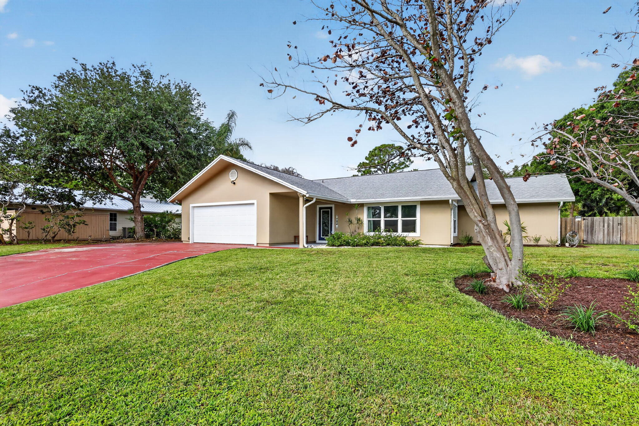 Live in a hidden gem in Hidden Bay, one of Palm City's most private non-HOA communities with canal and river access. Set on a half-acre lot among just 30 homes, this property offers privacy and flexibility. Freshly painted inside and out, it features a split floor plan, newer roof (2015), newer stucco (2017), full impact windows and doors, electric screened porch, new A/C, newer hot water heater, and luxury vinyl plank flooring throughout living areas. Enjoy a new jacuzzi on the patio and a spacious backyard—bring your boat, RV, and pool plans. Zoned for A-rated Bessey Creek Elementary School, this home offers both lifestyle and top-tier education.