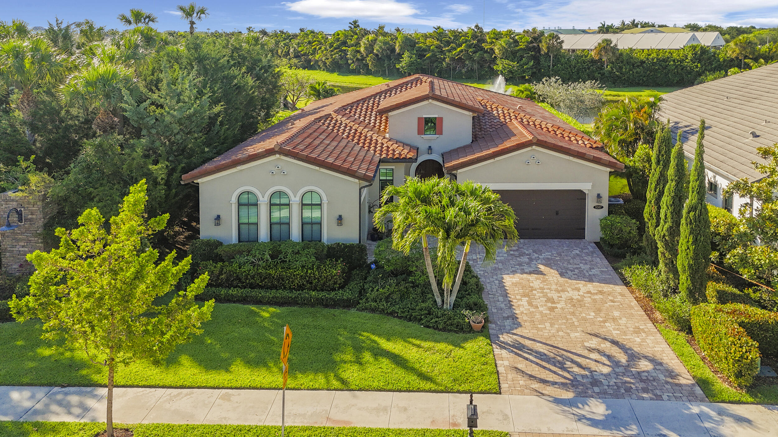 Welcome to 9387 Grand Prix Lane, a beautifully appointed residence in the highly sought-after Palm Meadows Estates of Boynton Beach. Perfectly positioned on a premium homesite with expansive greenspace next door, this property offers a rare combination of privacy, openness, and upscale South Florida living. Built in 2017, this spacious one story home features over 3,000 square feet of living space with 4 bedrooms and 3.5 bathrooms, thoughtfully designed for both everyday comfort and entertaining. From the moment you enter, you're greeted by soaring ceilings, abundant natural light, and a seamless open-concept layout. Impressive Built-in Closets and Spacious Pantry add to the Beauty and Functionality along with the Upgraded Window Treatments. The heart of the home is the chef's kitchen, complete with modern cabinetry, stainless steel appliances, and a large center island overlooking the main living and dining areas—ideal for gatherings. Living spaces provide flexibility for a home office, media room, or guest accommodations. Step outside to your private backyard retreat, where a sparkling pool invites you to relax and unwind. The adjacent greenspace enhances the sense of tranquility, offering extra breathing room and a level of privacy rarely found in the community. Whether you're hosting weekend barbecues or enjoying a quiet evening under the stars, this outdoor space delivers. Palm Meadows Estates is a gated community known for its resort-style amenities, including a clubhouse, fitness center, tennis courts, and more—all conveniently located near top-rated schools, shopping, dining, and major highways. This is a rare opportunity to own a premium lot home with a pool in one of Boynton Beach's most desirable communities. Schedule your private showing today.