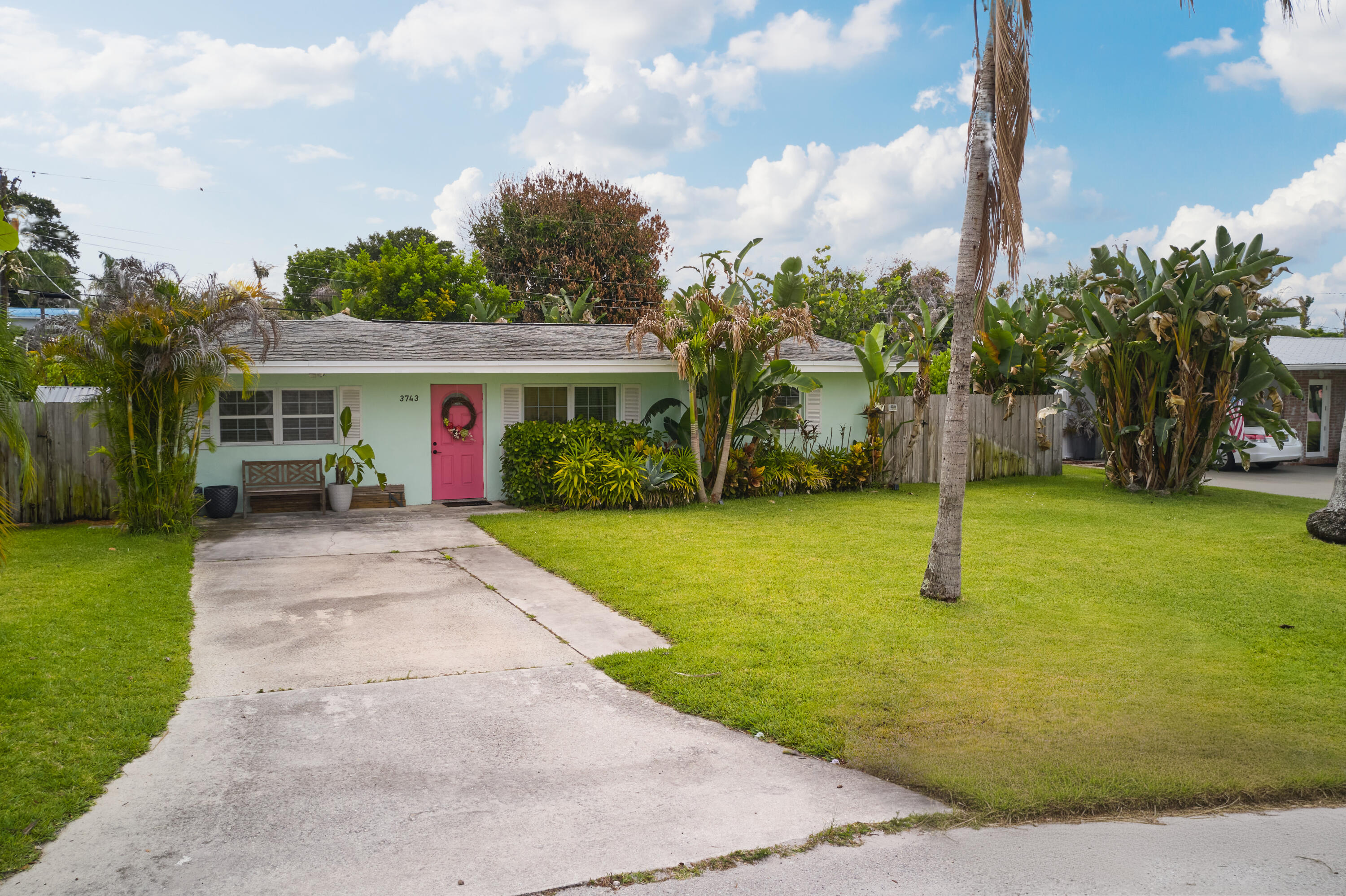 Welcome to your own tropical retreat just minutes from Downtown Jensen Beach! This solid concrete block home is tucked away on a quiet, low-traffic street surrounded by mature coconut palms and lush tropical landscaping. The fully fenced backyard offers a private oasis complete with a composite wood deck - the perfect spot to relax, unwind, or entertain guests. Inside, you'll find a spacious, thoughtfully updated interior with an open-concept kitchen beautifully renovated in 2024, featuring modern finishes and plenty of room for cooking, gathering, and everyday living. Both bathrooms were tastefully updated in 2024 as well. The oversized primary suite is a true retreat, offering an impressive 19' x 15' layout with plenty of space to spread out. Additional highlights include a large laundry room and No HOA, giving you the flexibility and freedom to enjoy your home your way. Located less than a mile from Downtown Jensen Beach, you're just a short walk or bike ride to local restaurants, shopping, live music, festivals, and community events. Plus, the beautiful Treasure Coast beaches are less than 10 minutes away! Don't miss the opportunity to own your own slice of paradise in one of Jensen Beach's most desirable locations.
