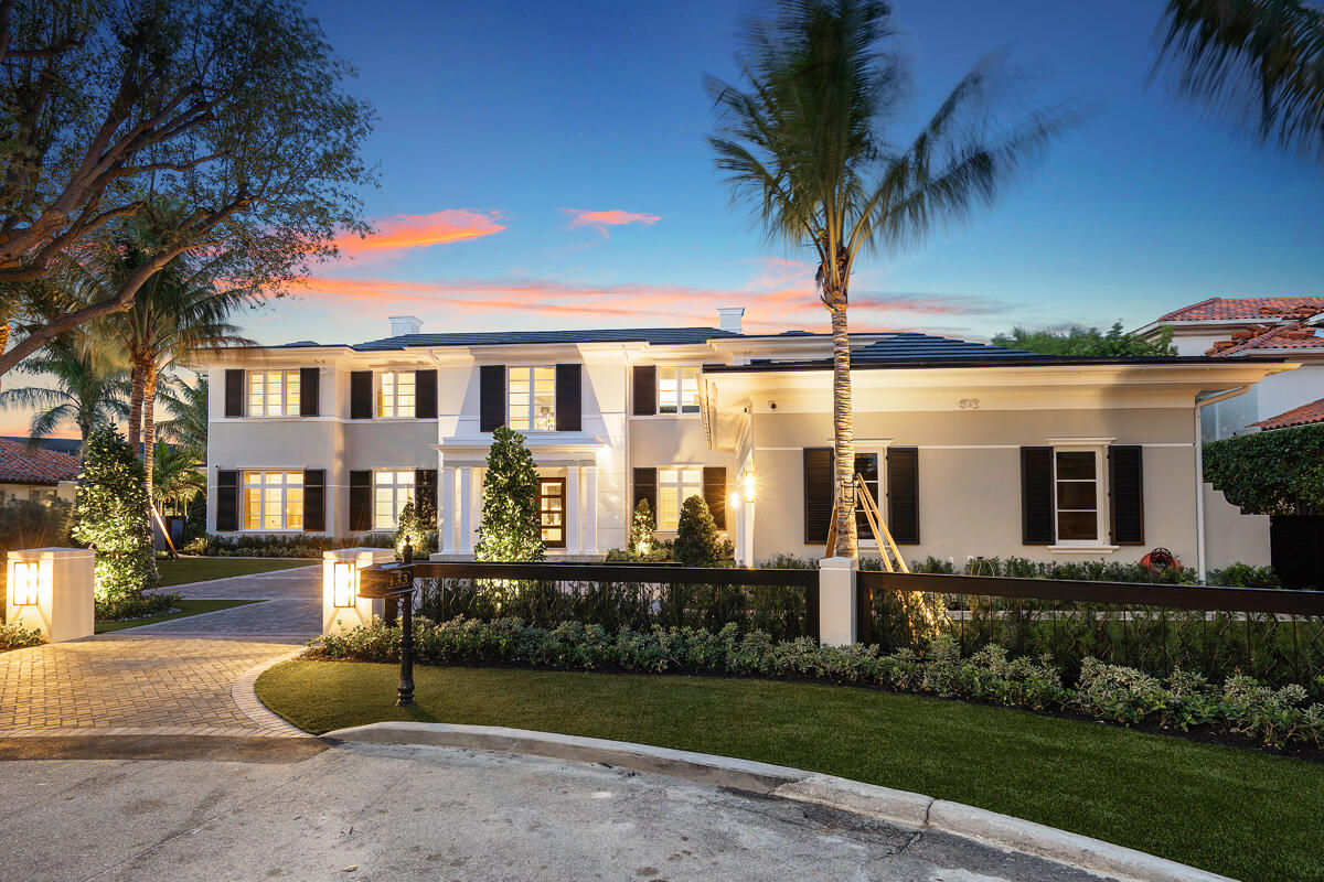 Set along 158 feet of the Butterfly Palm Waterway, 133 Coconut Palm Road is a waterfront estate by Wietsma Lippolis Construction, quietly positioned within Royal Palm Yacht & Country Club. Spanning over 8,400 square feet, the residence unfolds through a grand, open layout designed for both scale and ease of living. The main level transitions seamlessly from formal living and dining spaces to a well-appointed gourmet kitchen and family room, complemented by a club room with bar and wine cellar, a private library, and a flexible guest suite or fitness space. Upstairs, a secondary living area creates a natural sense of separation, accompanied by four en-suite bedrooms and a private primary suite with dual baths and dressing rooms, all oriented to capture calm, uninterrupted water views. Outdoors, a series of covered and open-air spaces frame the waterfront setting, where a summer kitchen, fire feature, and resort-style pool with spa are positioned to take full advantage of the home's expansive frontage. Originally constructed with a high level of finish and specification, the home presents a rare opportunity to secure scale, quality, and a refined waterfront lifestyle within one of the community's most established settings.