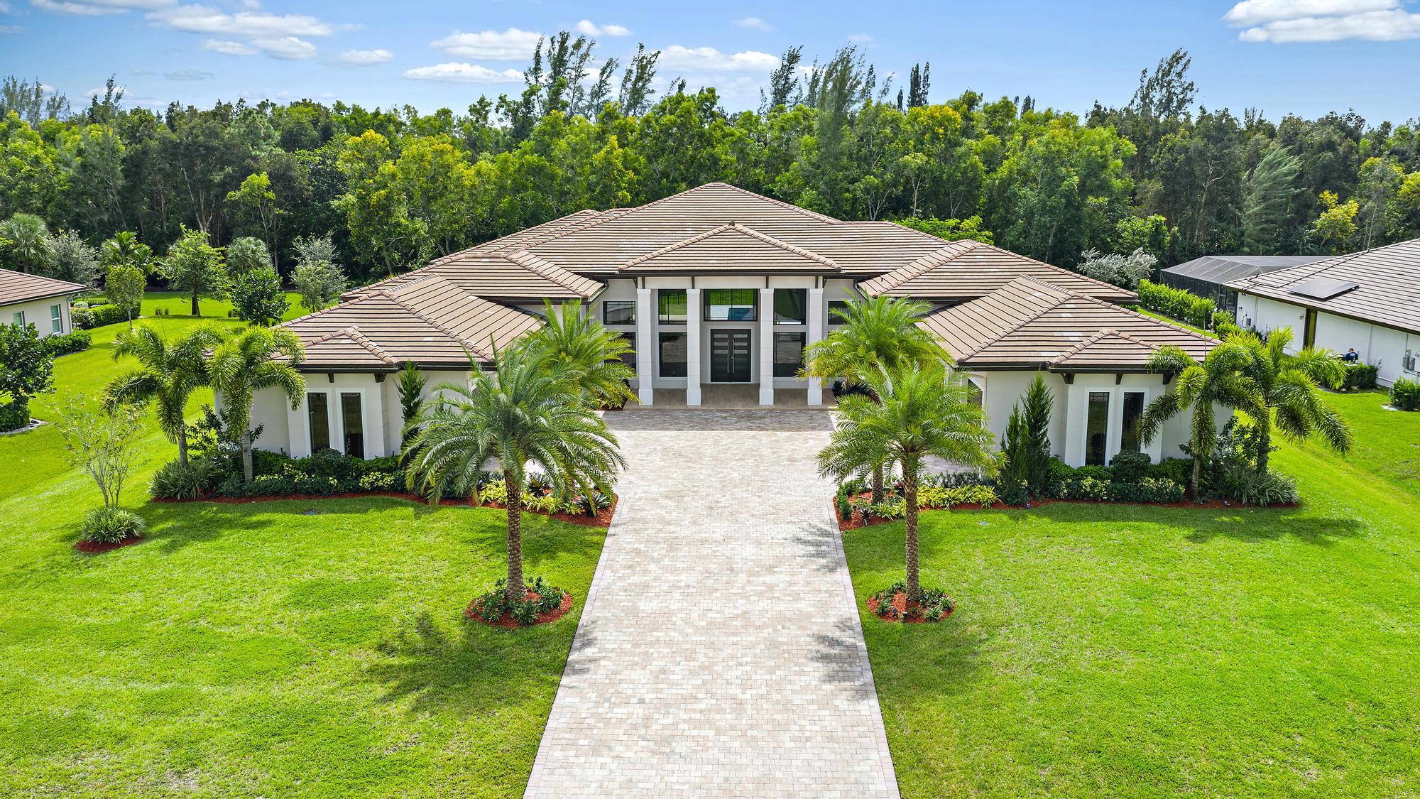 Architectural Masterpiece w/ approx 6599 of modern luxury living sqft ,professionally landscaped & backs to preserve. Prestigious sought after Bay Hill Estates location featuring solid European 8 foot doors w/concealed hinges, 11ft high impact resistant glass sliders in Great, Family, & both Master Bedrooms leads to approx. 1500+ sqft of lanai w/view of salt heated pool w/spa w/marble pool surround, abundance of large impact resistant windows, 17.5 ft high ceilings & 16.6 ft high ceilings, coffered ceilings, double & single tray ceilings, undermount lighting, spa like Master Baths w/double vanities & separate soaking tubs, spacious Modern European style Kitchen w/high end cabinetry & gorgeous oversized island, Porcelain countertops & backsplash, SubZero, Wolf & Miela appliances, prep kitc hen, 48 x 48 porcelain floors throughout, 4  car garage w/epoxy flooring & 12 foot wide doors, covered large portico, sound insulation throughout interior walls & MBR ceiling, wood look porcelain tile on patio. Bay Hill Estates is a premier golf course, PGA National Golf Course community known for its stunning single-family residences on spacious 1-acre lots. These homes offer breathtaking views of the scenic premier Golf Course and tranquil lakes. Residents can enjoy peaceful walks along paths that wind by canals and lakes, adding to the community's serene atmosphere. Our community combines luxury with convenience and security, featuring low Property Owners Association (POA) fees that cover essential services such as cable TV, internet, and 24-hour security. Additionally, Bay Hill Estates is ideally located just a 30-minute drive from the exquisite shopping and dining in Palm Beach Gardens and the pristine beaches of Palm Beach County, providing residents with easy access to the best the area has to offer.