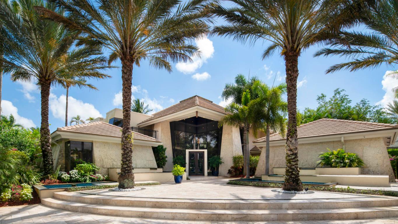 Stunning estate home sits on an oversized lot with breathtaking views of the lake and fairway in the exclusive gated enclave of Princeton Estates in Woodfield Country Club. Soaring peak cypress ceilings, coral rock walls and a dramatic 2-sided fireplace make this home truly unique. Full bar, screened patio and 2 large dining areas are perfect for entertaining.  Enjoy lavish parties at your resort style pool with slide overlooking the lake with natural gas outdoor grill & fire pit. Three bedrooms plus office downstairs and three full bedrooms and gym upstairs make this a great layout for your entire family plus guests.  Enjoy cooking gourmet meals in the ktichen with Miele appliances and lovely porcelain farmhouse sink.  Live the best life Florida has to offer.