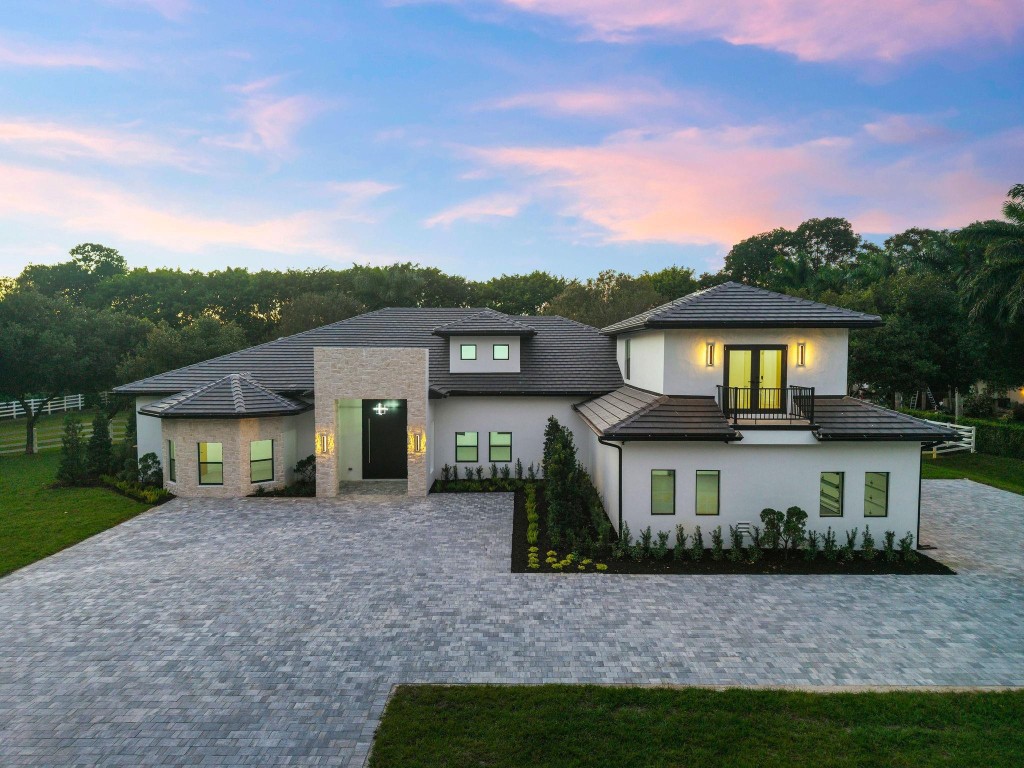 ***COMPLETELY RENOVATED FROM HEAD TO TOE—EVERYTHING IS BRAND NEW!!!*** SITUATED ON NEARLY 2 ACRES IN THE HEART OF SUNSHINE RANCHES, THIS EXCEPTIONAL ESTATE OFFERS 6 BEDROOMS, 5 FULL BATHS PLUS A POWDER ROOM, WITH 4,786 SF OF A/C SPACE AND 6,667 SF UNDER ROOF, INCLUDING A 3-CAR OVERSIZED GARAGE, PATIO, AND COVERED ENTRY. A STRIKING 10’9'' WOOD PIVOT DOOR OPENS TO SOARING CEILINGS, A TRIPLE-SPLIT LAYOUT, AND OPEN-CONCEPT DESIGN. THE TWO-TONE MODERN KITCHEN FEATURES EXTENSIVE FLOOR TO CEILING CABINETRY, QUARTZ WATERFALL COUNTERTOP W/STOOLS, THERMADOR APPLIANCE PACKAGE W/GAS COOKTOP. PORCLAIN FLOORS ON FIRST FLOOR WITH WOOD TILE ON SECOND FLOOR. A PRIVATE OUTDOOR OASIS INCLUDES COVERED PATIO W/WOOD CEILINGS, SUMMER KITCHEN, POOL/SPA, TANNING SHELVE AND LUSH GREENERY. CITY WATER!
