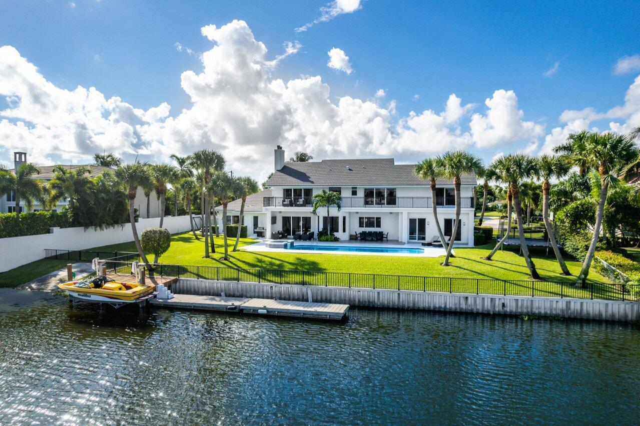 305 Lake Eden Way is a stunning waterfront estate in the highly sought-after Lake Ida neighborhood of Delray Beach, Florida. This exceptional Florida home is sure to impress you with its open, spacious, spectacularly renovated living areas that fully capture sweeping wide water views north up the center of tranquil Lake Eden from every room. State of the art hurricane proof windows and doors, gorgeous real wood flooring, a gourmet kitchen with a Wolf range, Sub-Zero refrigerator, Sub-Zero wine tower and an expansive white quartzite island will impress the most discriminating audience. This Lake Eden waterfront estate in Delray Beach's most prime family neighborhood truly offers the most complete, amazing and happy lifestyle. A rare opportunity to have it all on the Floridian waterfront. 305 Lake Eden Way is a stunning, waterfront estate in the highly sought-after Lake Ida neighborhood of Delray Beach, Florida. This open, spacious and beautifully renovated home is sure to impress you with its views capturing the sweeping, wide water panorama up the center of tranquil Lake Eden from almost every room. This residence spans approximately 5,100 square feet under air with an expansive open living area, 5 bedrooms, 5 bathrooms, a den, and a covered patio downstairs, a lakeview balcony that spans the entire length of upstairs of the home, and an over-sized 3 car garage.   Hurricane- proof windows and doors, real wood flooring throughout, and a gourmet kitchen with Wolf range, Sub-Zero refrigerator, Sub-Zero wine tower and an expansive white quartzite island all combine beauty, function and comfort to the highest standards. Two primary suites with ensuite baths are located upstairs and three bedrooms downstairs. Natural light illuminates the open floor plan and a floor-to-ceiling white stone, wood-burning fireplace provides an inviting feel to the sprawling great room.  

This gracious home is situated on a secluded, quiet cul-de-sac. A new dark slate roof was installed in 2021. The substantial ½ acre property includes a large pool with spa, two docks, a motorized boat lift, a boat launch ramp, a 6' privacy wall and is completely enhanced by lush landscaping. The driveway has a gated side section for boat and RV parking. Lakes Ida and Eden offer powerboating for watersports, fishing and wave runners. 

While breathtaking views and the peaceful serenity of water are showcased in practically every room, the interior itself is unparalleled by having been renovated to the highest standard with the finest appliances, fixtures and finishes.  The kitchen features a massive island with a gleaming white quartzite countertop.  White custom kitchen cabinets with modern chrome handles gel perfectly with the black countertops. A 48" Sub-Zero refrigerator looks handsome across from the bar area which is accentuated by a Sub-Zero wine tower with a 146-bottle capacity. The 60' Wolf range has 6 burners, a griddle, 2 ovens and distinctive red knobs.  Dual dishwashers stand on either side of the sink.  Gorgeous real wood floors flow throughout the house.  Several sets of hurricane-proof triple sliding glass doors span across both floors of the house welcoming abundant lake views and natural light. Outside is a covered patio for entertaining and outdoor dining.  An illuminated 15' x 40' pool with spa provides fun and relaxation day and night. For boaters, there is both a dock on pilings with an electronic boat lift and a (insert dock dimensions here) floating metal dock, as well as a ramp for launching your wake, surf or fishing powerboat.  

Delray Beach, Florida is one of the most sought-after cities in the United States. The Lake Ida neighborhood with its spacious lot sizes typically ranging from ¼ to ½ acre is one of the most desirable areas within Delray Beach because of its proximity to pristine beaches, beautiful ocean and lively downtown Atlantic Avenue. "Downtown Delray" bustles with its array of restaurants, galleries, shops and nightlife.  It also features several 5-star hotels including the Opal Grand Resort, The Seagate and The Ray.

Lake Eden living is ideal for families. You and your family will get the best of all lifestyles: athletics and fitness, socializing, entertaining and being entertained.  In addition, a half dozen top ranked private schools are within minutes by car, golf cart, bicycle or walking. This Lake Eden waterfront estate in Delray Beach's prime neighborhood truly offers the most complete, amazing and happy lifestyle imaginable. This is a rare opportunity to have it all on the Floridian waterfront.