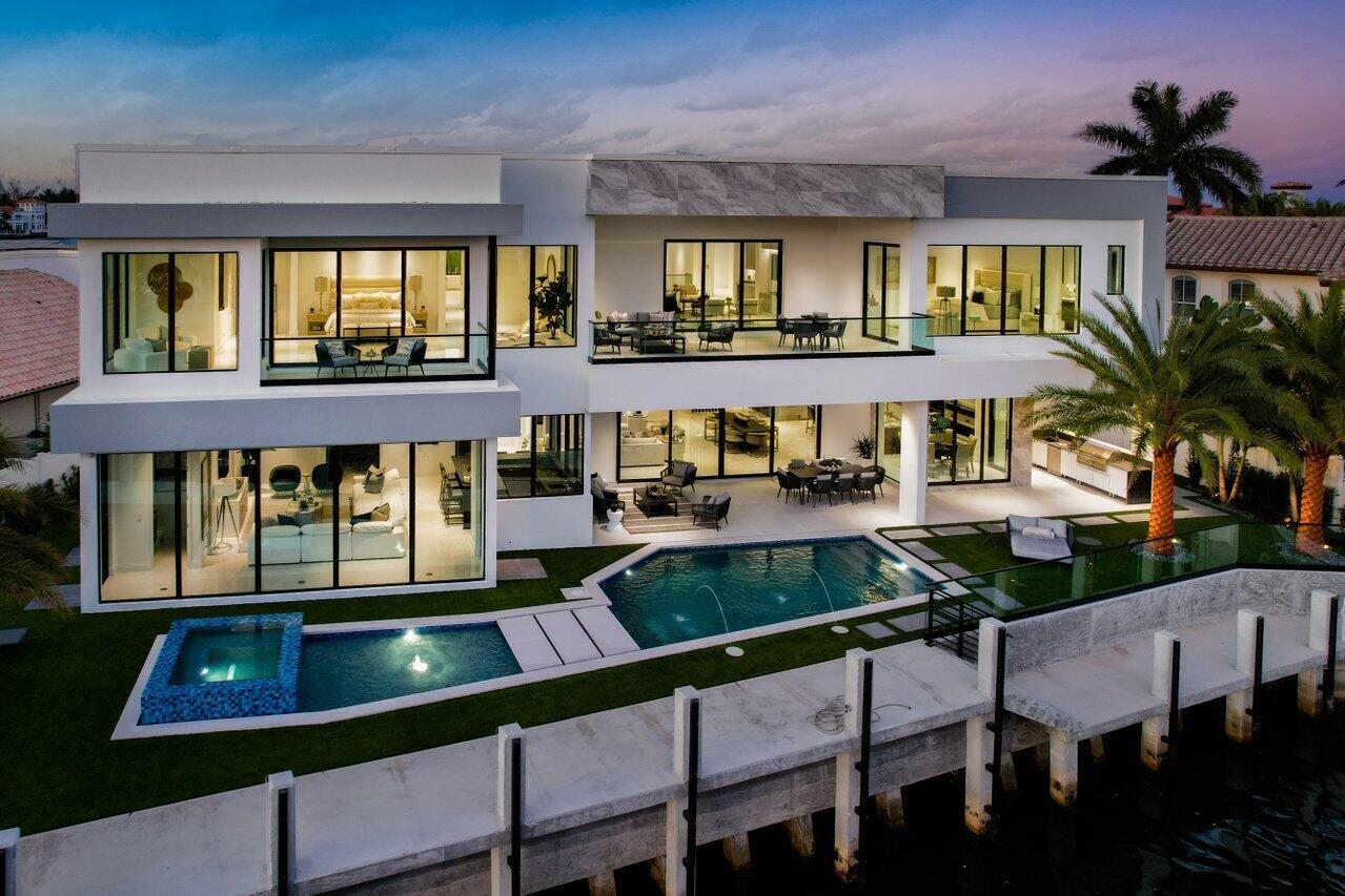 Brand new construction, completed in April of 2023 and nestled in one of South Florida's most prestigious waterfront communities, Sun & Surf—749 Bamboo Drive is a custom contemporary masterpiece that captivates you with its elegant simplicity and its modern design. The thoughtful layout includes 7,502 square feet of interior living space, with six bedrooms and eight bathrooms. The open, two-story layout flows with clean lines and an array of unique finishes and details. Premium, modern kitchen features Sub-Zero 72'' wide refrigerator, six burner Wolf gas range, dual Wolf wall ovens, a Ruvati 57'' two-tiered workstation, and a large walk-in pantry with second refrigerator. Interior highlights include 12' ceilings on the first floor, elevator with large window and touchscreen controls, impact glass throughout, four-zone air conditioning with linear diffusers, center-stringer style staircase with floating treads and glass rail, 20' wide sliding glass doors, club room with wet bar, primary suite with dual sitting areas, fully-recessed TV ceiling hinge by Future Automation that accommodates a 75" flat screen tv, large covered balcony with glass railing and a primary bath with zero-entry shower with full slab porcelain walls and oversized soaking tub.