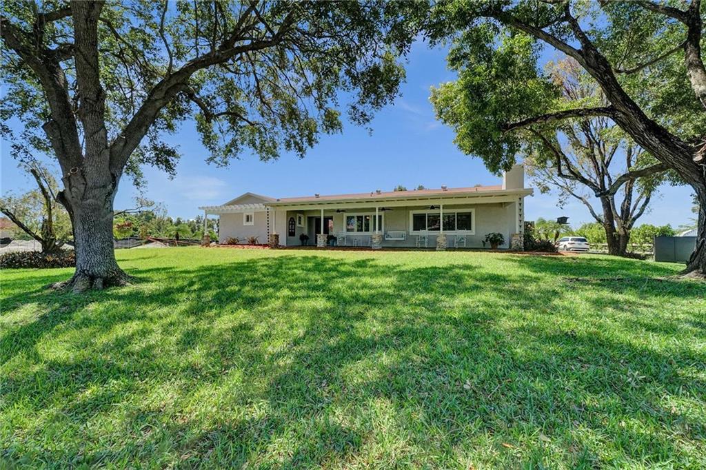Nestled in SW Ranches, this home of 4 bed 2 bath offers an unrivaled living experience that blends indoor & outdoor living. With an exquisite pool with gazebo & waterfall, the resort-style backyard spans over 2,000 sf of Travertine, providing the perfect ambiance for relaxation & entertainment. Sellers have made this home the ultimate gathering place with an extended front porch & a huge screened back patio, an inviting atmosphere that is both luxurious & comfortable. Step inside to see a custom kitchen with a large island for creating culinary delights, remodeled baths, living, family, & multi-purpose rooms provide ample space for all your needs. This home also features impacts, 2 car garage, 280ft deep well, hurricane-rated shed, & highly-rated schools, making it the epitome of living.
