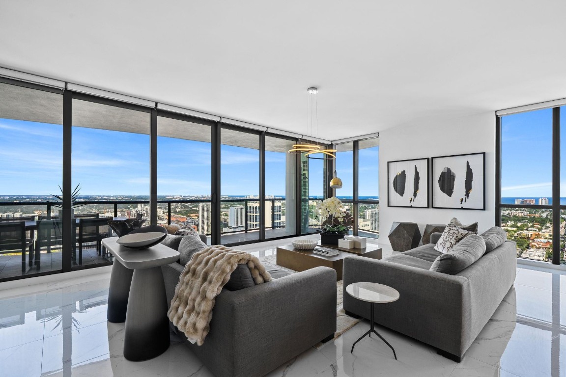 Rising above the Skyline of Downtown Fort Lauderdale, Residence 4001 at 100 E Las Olas delivers the ultimate in modern Luxury & Energy! This Rare & Unique Sky Estate combines Two Residences into a Breathtaking showplace with 4 bedrooms, 4.5 baths, a theatre, family room, formal dining area and more! Step off your Private Elevator into soaring style, surrounded by floor-to-ceiling glass and panoramic Ocean and City views that Sparkle Day and Night. An oversized terrace creates the perfect indoor-outdoor flow for entertaining or relaxing above it all! Sleek European cabinetry, quartz finishes, & designer appliances define perfection. Live in the heart of Las Olas, where fine dining, shopping, and entertainment are just steps away. Experience the excitement & schedule your Private Tour today!
