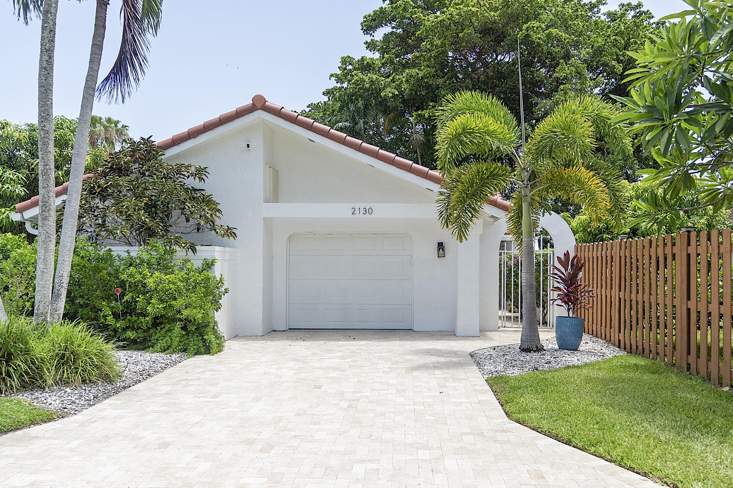 Experience elevated living at 2130 NW 12th, a beautifully renovated residence offering 1,951 total square feet of thoughtfully designed living space. This move-in-ready home features a brand-new roof and windows, along with 3 spacious bedrooms and 2 beautifully updated bathrooms, seamlessly blending modern comfort with timeless style. The bright, open-concept floor plan is enhanced by designer ceramic tile flooring throughout, creating a clean and sophisticated aesthetic. The gourmet kitchen boasts stainless steel appliances, an instant hot water dispenser, and ample space for both everyday living and entertaining. Step outside to a screened patio overlooking a fully fenced, private backyard—perfect for relaxing, hosting gatherings, or enjoying Florida's year round outdoor lifestyle.