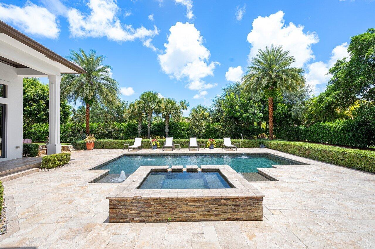 Stunning nearly 5,000 sq ft, 4 bedroom plus den/office, custom estate home situated on 1.03 acres in the exclusive gated community of Steeplechase. All guest suites offer ensuite bathrooms with potential 5th bedroom located in the guest bedroom wing. Light and Bright gourmet kitchen featuring all Thermador appliances, spacious breakfast nook, oversized island, built in wine cooler, custom cabinetry, and more. Spacious Primary Suite with three walk-in closets, luxurious bath with large soaking tub, oversized shower, and separate dual vanities. This incredibly spacious home also offers a game room with wet bar and 1/2 bath with access to the gorgeous backyard, plus additional bonus room at the end of the guest wing that could easily be converted to 5th bedroom. The outdoor private oasis is the perfect space for entertaining with heated salt pool & spa with sun shelf, custom stone fire pit, putting green, large covered patio with wood planked ceiling and bar, built in grill, and so much more! Other features include complete impact glass, custom temperature controlled wine wall cellar, stunning architectural details throughout, marble flooring, and much more. Call for your private tour today!