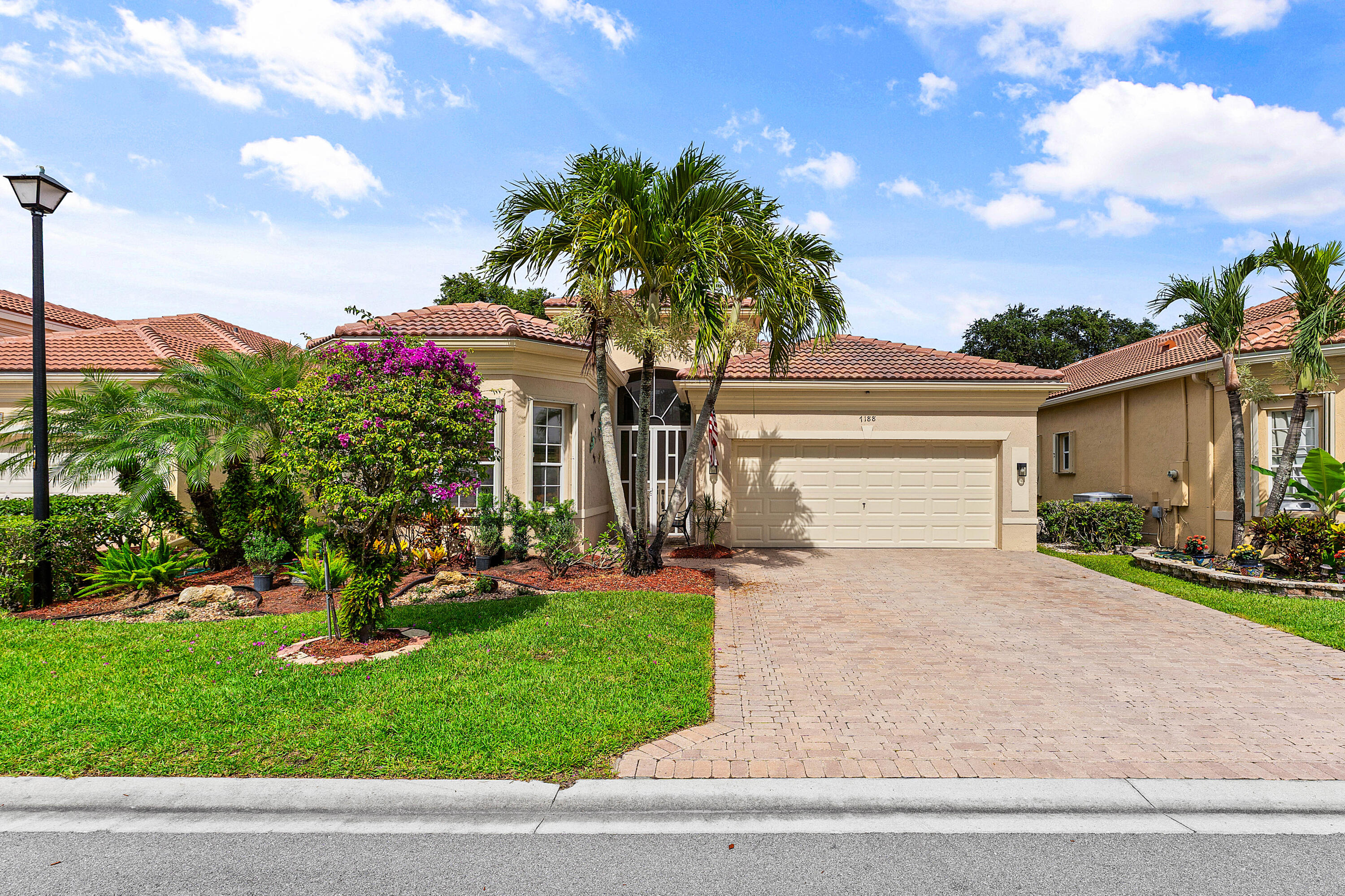 Welcome to this beautifully maintained, home in the highly sought-after Vizcaya community of Delray Beach. Step inside to soaring 13-foot ceilings and an open, light-filled floor plan designed to showcase the stunning water views from the living room and covered lanai. This spacious 2-bedroom, 2-bathroom residence with a versatile den offers an exceptional blend of comfort, quality, and breathtaking lakefront views.  Numerous builder upgrades throughout reflect exceptional pride of ownership and attention to detail. The well-appointed kitchen features newer appliances, while major mechanical systems have also been updated for added peace of mind. The bedrooms and den are enhanced with newer wood-look tile flooring, offering both style and durability.  Outside, enjoy freshly landscaped grounds and relax on the covered lanai overlooking the tranquil lake—an ideal setting for morning coffee or evening sunsets. The spacious 2-car garage includes custom storage solutions, providing excellent organization and functionality. Beyond the home, residents enjoy the exceptional lifestyle that Vizcaya is known for. The impressive 22,000-square-foot clubhouse features a state-of-the-art fitness center with saunas and locker rooms, card rooms, billiards, library, arts and crafts studio, coffee bar, ballroom, and numerous social gathering spaces. Outdoor amenities include a resort-style heated pool and spa, tennis courts, pickleball courts, bocce courts, walking and biking paths, and beautifully maintained common areas. An active social calendar offers fitness classes, clubs, community events, and endless opportunities to connect with neighbors and enjoy South Florida living at its finest.