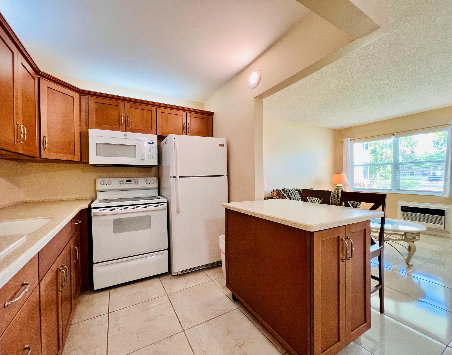 THE PERFECT PLACE TO CALL HOME IN 55+ CENTURY VILLAGE! FIRST FLOOR & PET FRIENDLY!! Adorable 1/1 With Updates! Pretty Open & Updated Kitchen Featuring Shaker Style Soft Close Cabinets, Solid Surface Cabinets, and Movable Island. Large Bedroom With Wall of Closets and Access to the Lanai. Large Format Neutral Tile Flooring Throughout. Updated Impact Front Windows. Nicely Maintained Building With Resident Patio, Reserves, and Roof (2019). Association Allows Pets - 1 Cat or Dog Max 20lbs Per Unit. Sold Furnished As Shown. Quiet Location Yet Close to the Popular Kent Pool. Century Village is a vibrant 55+ Community Centrally Located In Beautiful Palm Beach County! Enjoy An Active Lifestyle With Resort Style Amenities... Century Village is a 55+ Resort Style community with so much to offer - Much To Offer - shows, movies, clubs, pools, security, and transportation service. The Clubhouse features a theater, indoor pool, card room, community/party room, billiard room, shuffleboard, tennis, pickleball, bocce, and two outdoor pools, Numerous heated outdoor pools throughout the community. Separate fitness center with gym and outdoor heated pool & resistance pool. Two guarded gates and 24-hour roving security patrol.